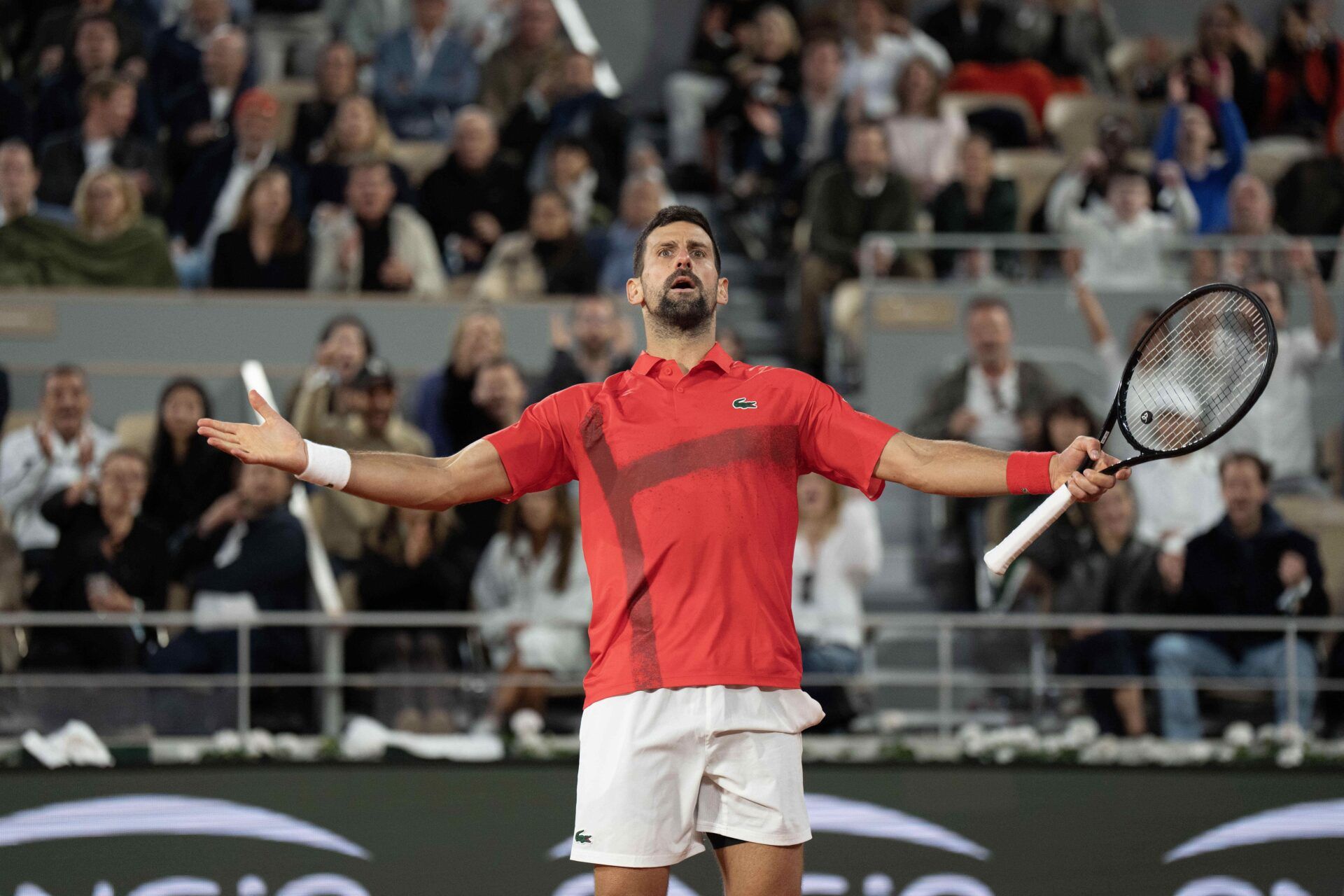 Novak Djokovic of Serbia reacts to a point during his match against Jannik Sinner of Italy on day 13 at Roland Garros Stadium.