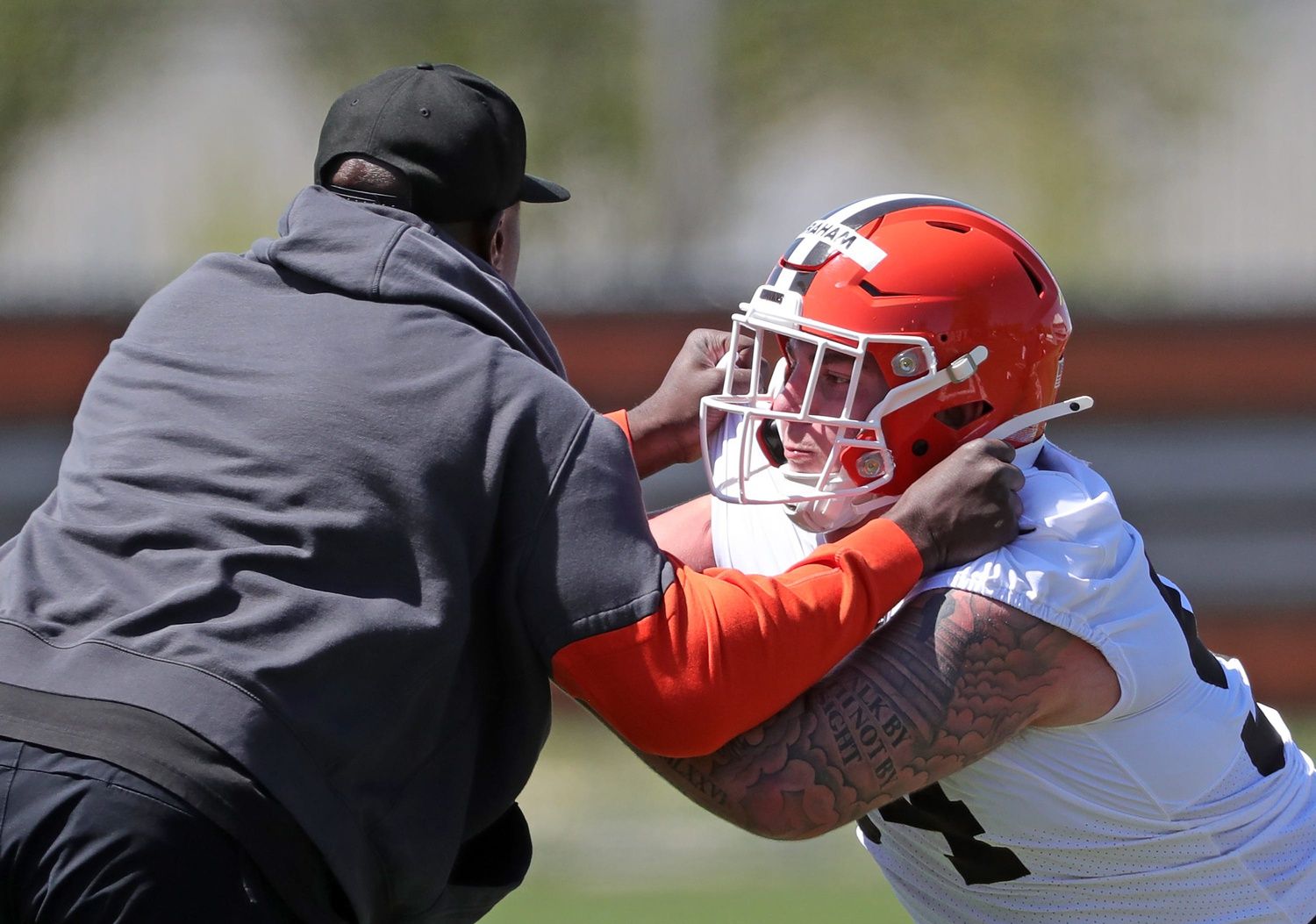 Cleveland Browns defensive tackle Mason Graham (94) works with defensive line coach Jacques Cesaire during NFL rookie minicamp at the Cleveland Browns training facility on Friday, May 9, 2025, in Berea, Ohio.