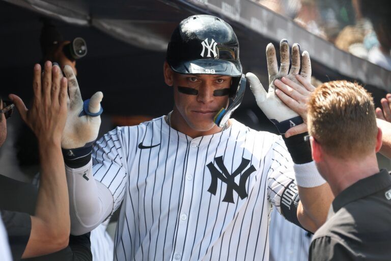New York Yankees designated hitter Aaron Judge (99) celebrates with teammates after hitting a two run home run during the fourth inning against the Athletics at Yankee Stadium.