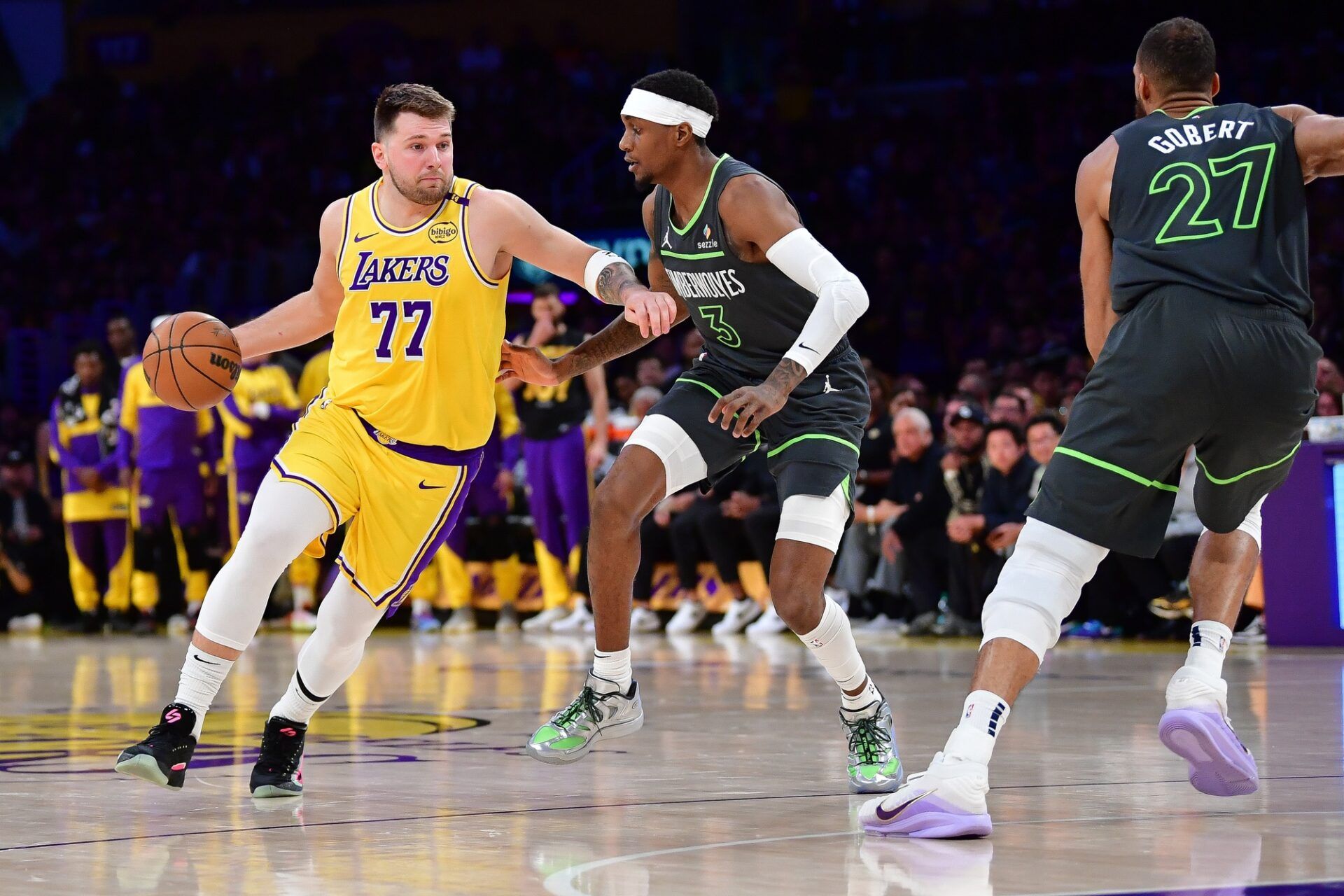 Los Angeles Lakers guard Luka Doncic (77) moves the ball against Minnesota Timberwolves forward Jaden McDaniels (3) during the first half in game five of first round for the 2025 NBA Playoffs at Crypto.com Arena.