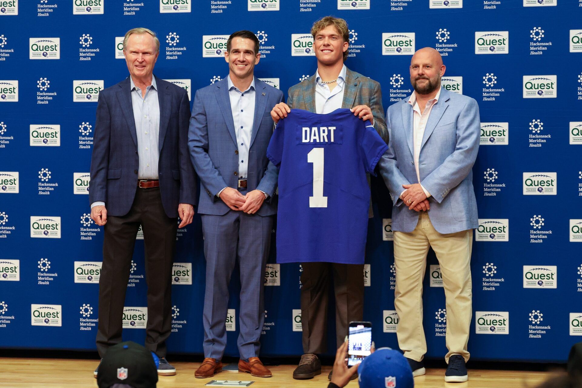 New York Giants president John Mara (far left), general manager Joe Schoen (left), Jaxson Dart, and head coach Brian Daboll (right) pose for photos prior to the start of the press conference to introduce the Giants first round draft picks.