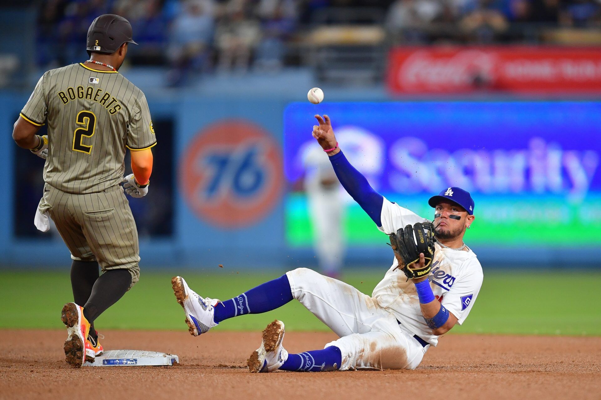 San Diego Padres shortstop Xander Bogaerts (2) is out at second as Los Angeles Dodgers shortstop Miguel Rojas (11) throws to first during the sixth inning at Dodger Stadium.
