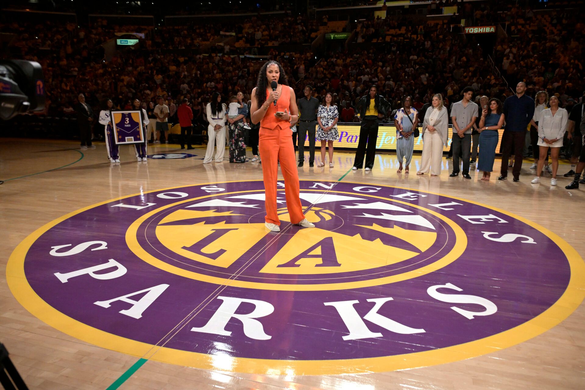 Former Los Angeles Sparks Candace Parker talks to the crowd during a her jersey retirement ceremony at halftime at Crypto.com Arena.