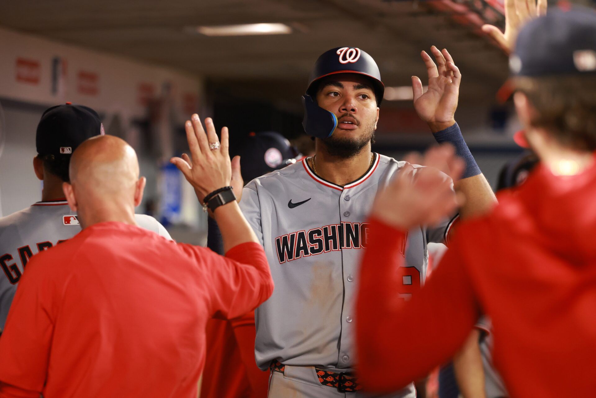 Washington Nationals left fielder James Wood (29) is greeted in the dugout after scoring a run during the eighth inning against the Los Angeles Angels at Angel Stadium.