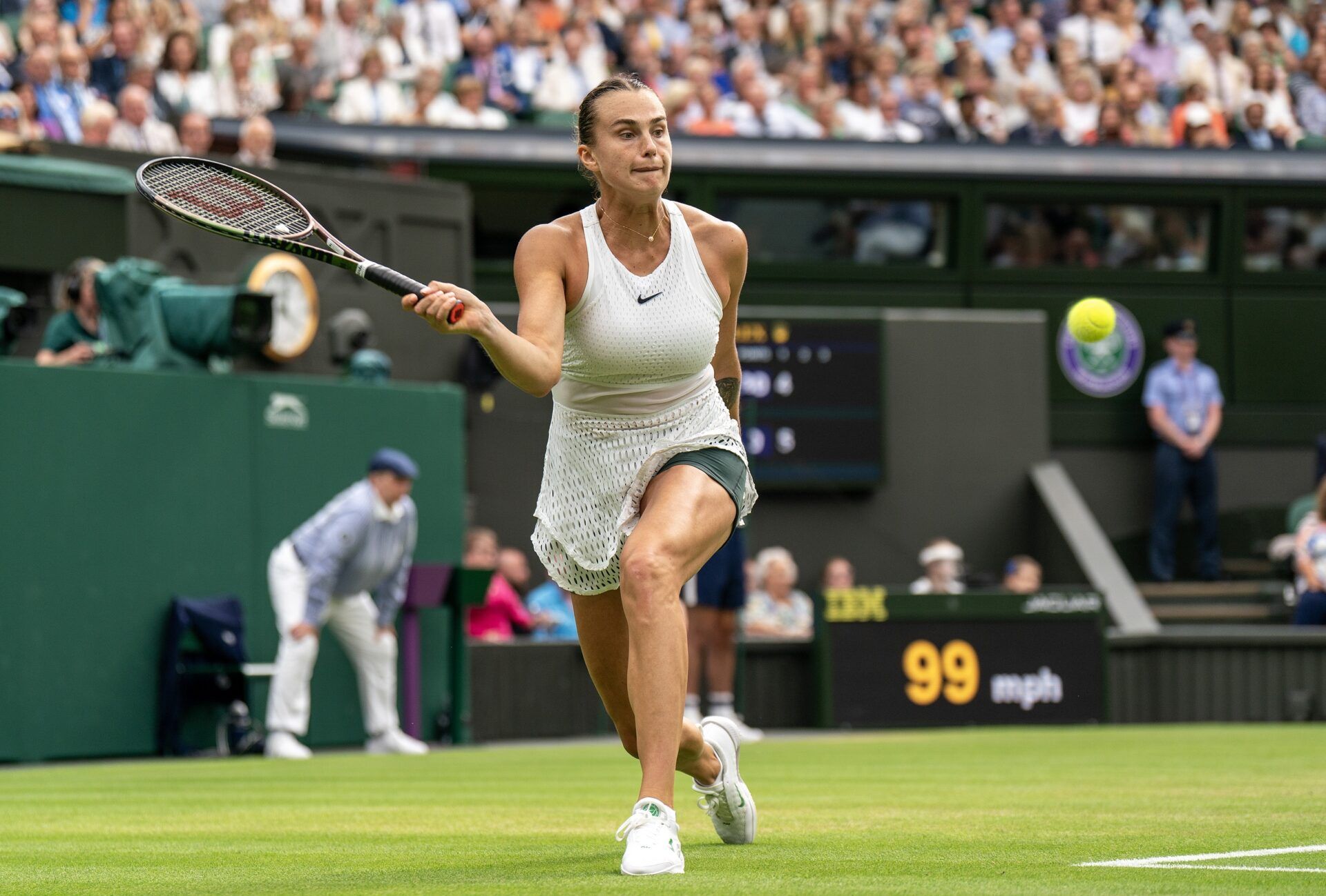 Aryna Sabalenka returns a shot during her match against Ons Jabeur (TUN) on day 11 at the All England Lawn Tennis and Croquet Club.