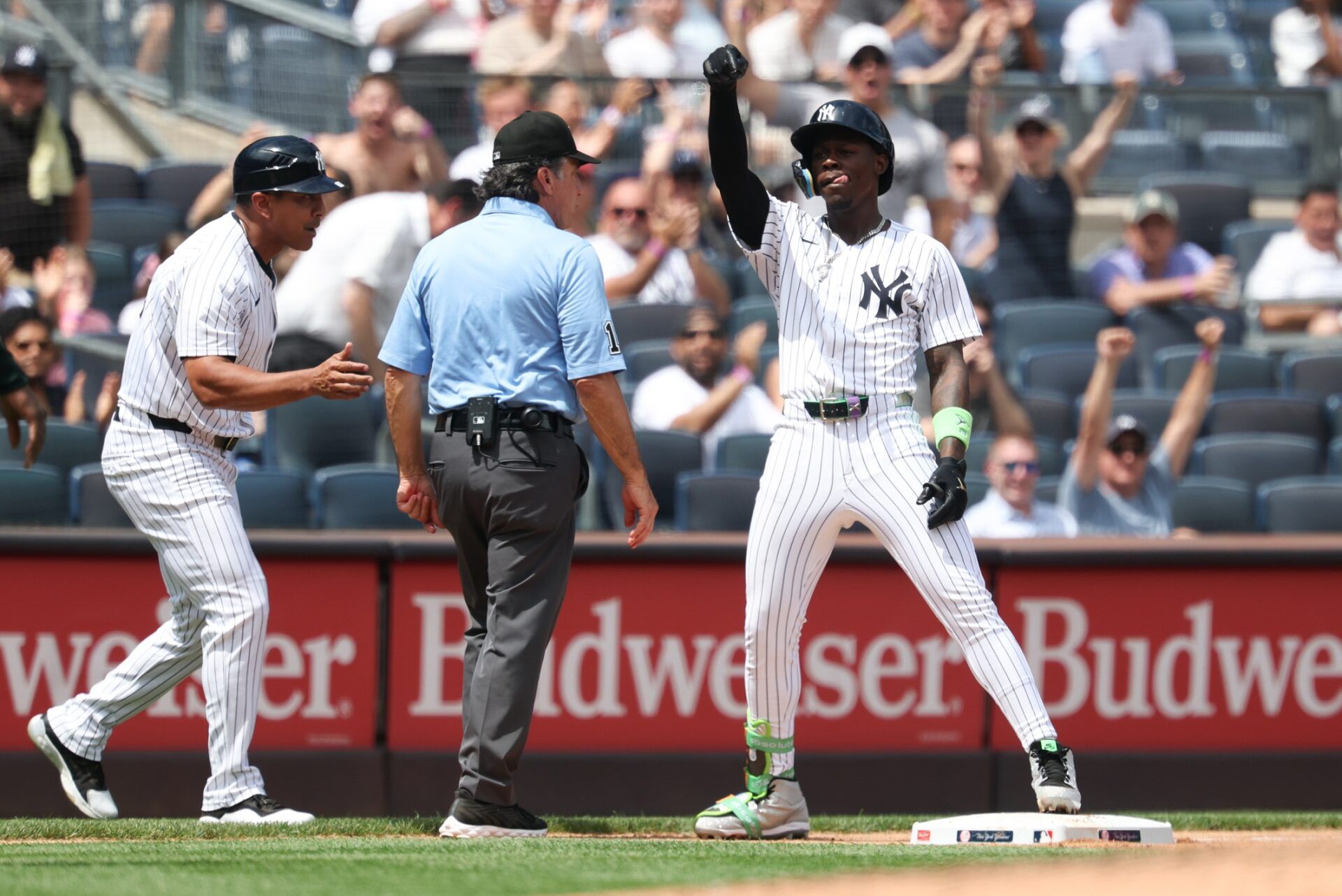 New York Yankees second base Jazz Chisholm Jr. (13) reacts after reaching third base on a  three run triple during the third inning against the Athletics at Yankee Stadium.
