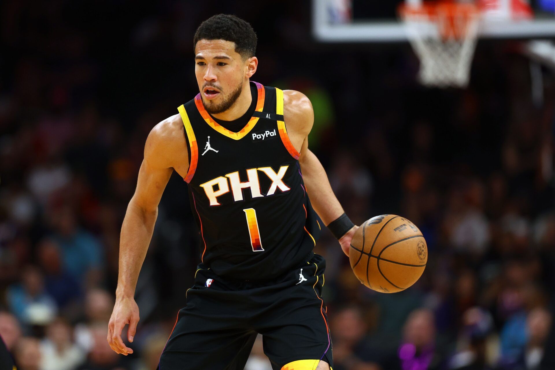 Phoenix Suns guard Devin Booker (1) dribbles the ball against the Oklahoma City Thunder during the first half at Footprint Center.