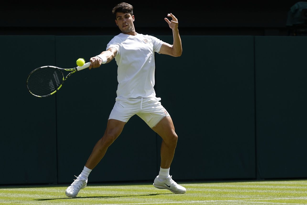 Carlos Alcaraz (ESP) hits a forehand against Fabio Fognini (ITA)(not pictured) on day one of The Championships, Wimbledon 2025 at All England Lawn Tennis and Croquet Club.