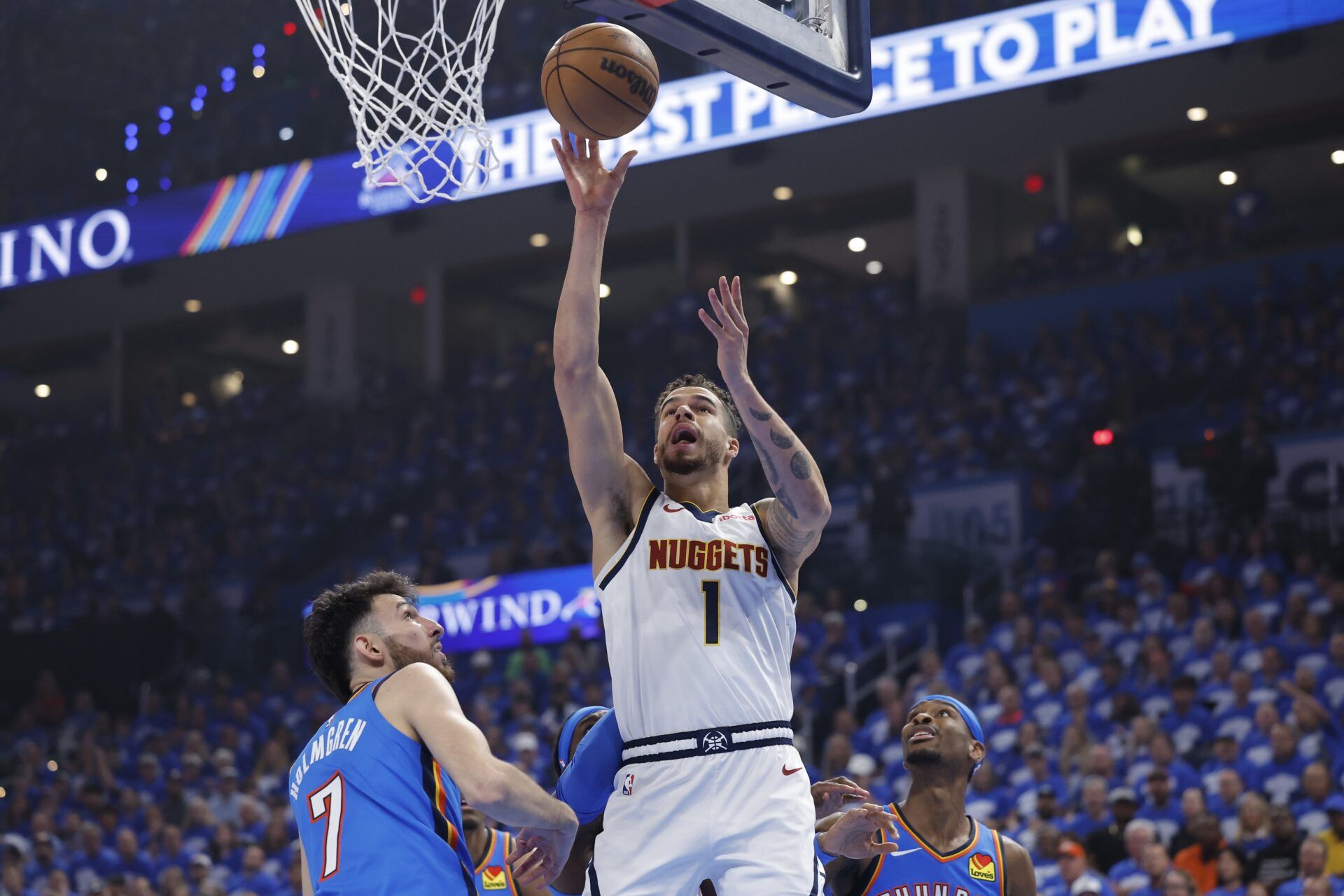 Denver Nuggets forward Michael Porter Jr. (1) shoots beside Oklahoma City Thunder forward Chet Holmgren (7) in the first quarter during game seven of the second round for the 2025 NBA Playoffs at Paycom Center.