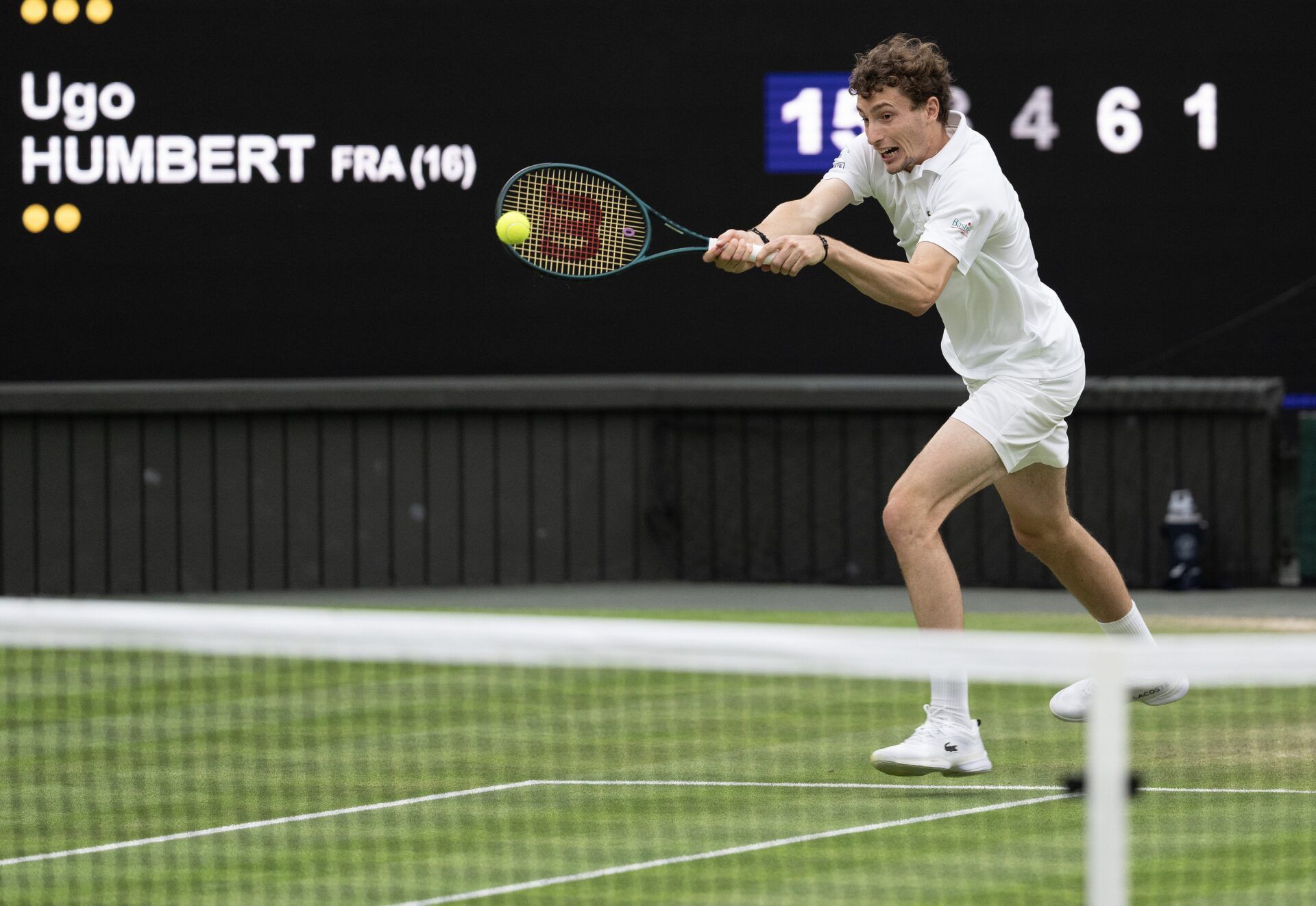 Ugo Humbert of France returns a shot during his match against Carlos Alcaraz of Spain (not shown) on day seven of The Championships at All England Lawn Tennis and Croquet Club.
