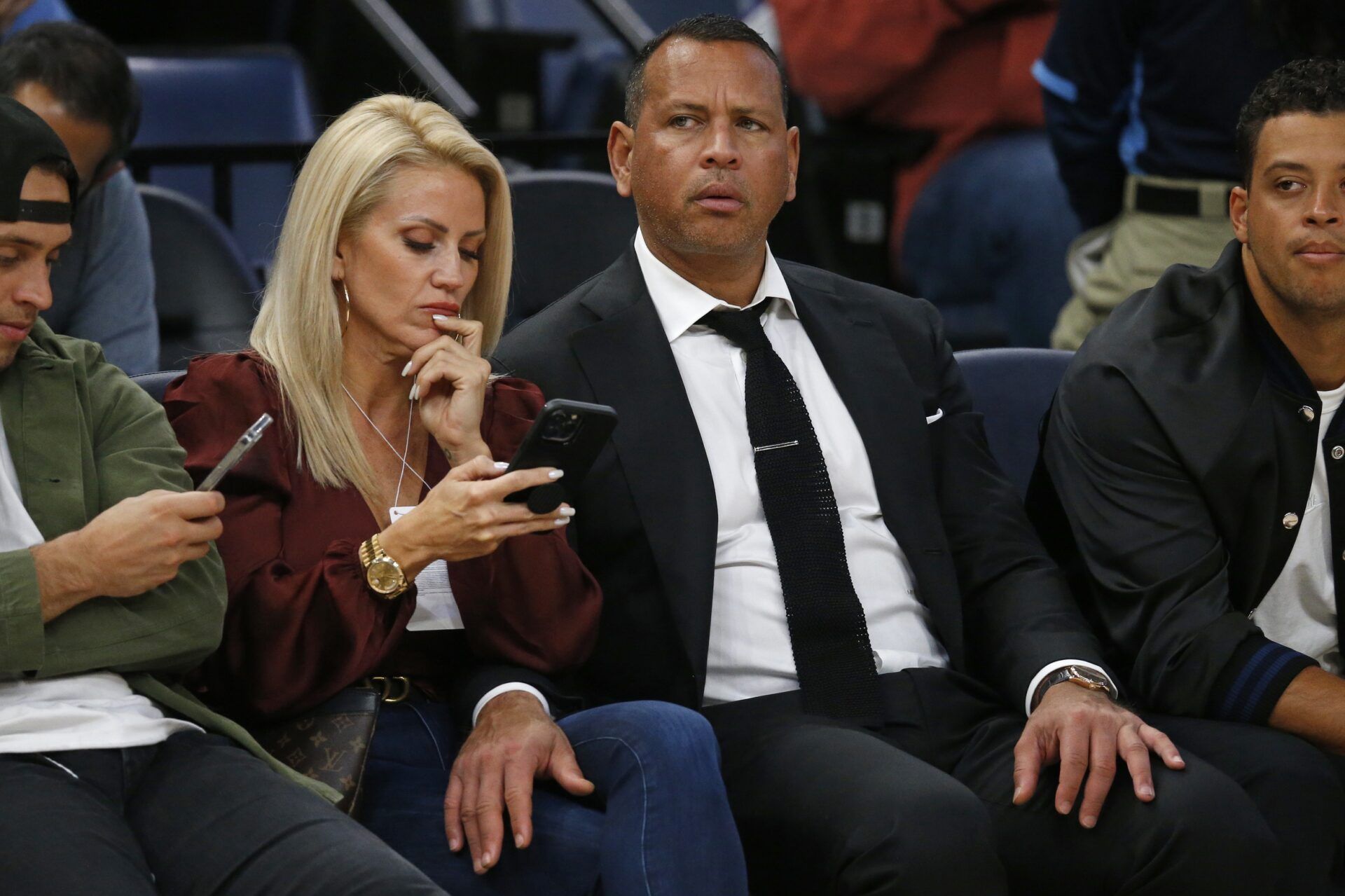 MLB former player Alex Rodriguez sits on the sideline with Jac Cordeiro before the game between the Minnesota Timberwolves and the Memphis Grizzlies at FedExForum.