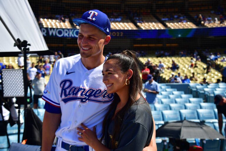 Texas Rangers shortstop Corey Seager (5) poses for a photograph with wife Madisyn during batting practice at Dodger Stadium.