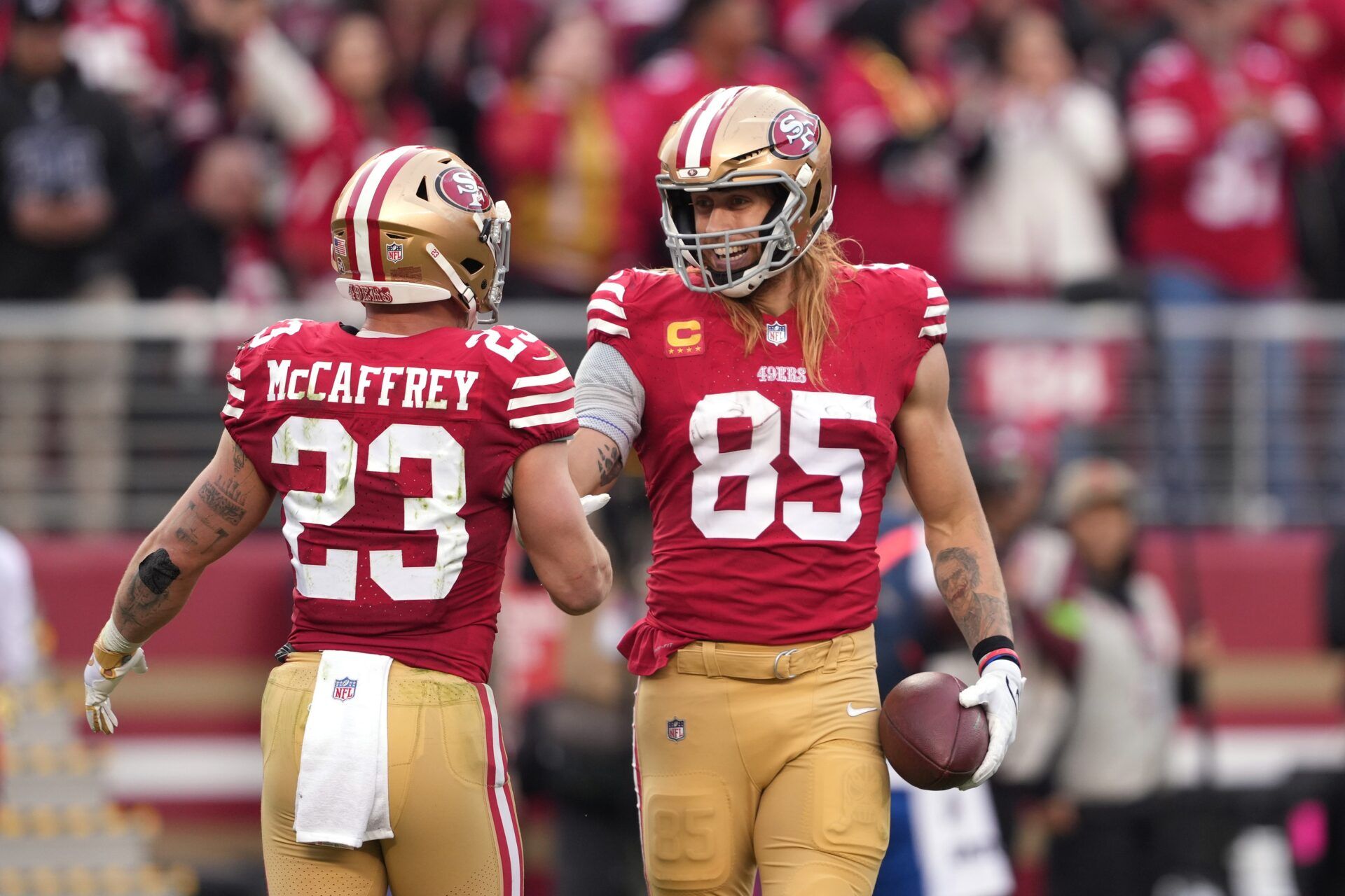 San Francisco 49ers tight end George Kittle (85) celebrates with running back Christian McCaffrey (23) after scoring a touchdown against the Seattle Seahawks during the fourth quarter at Levi's Stadium.