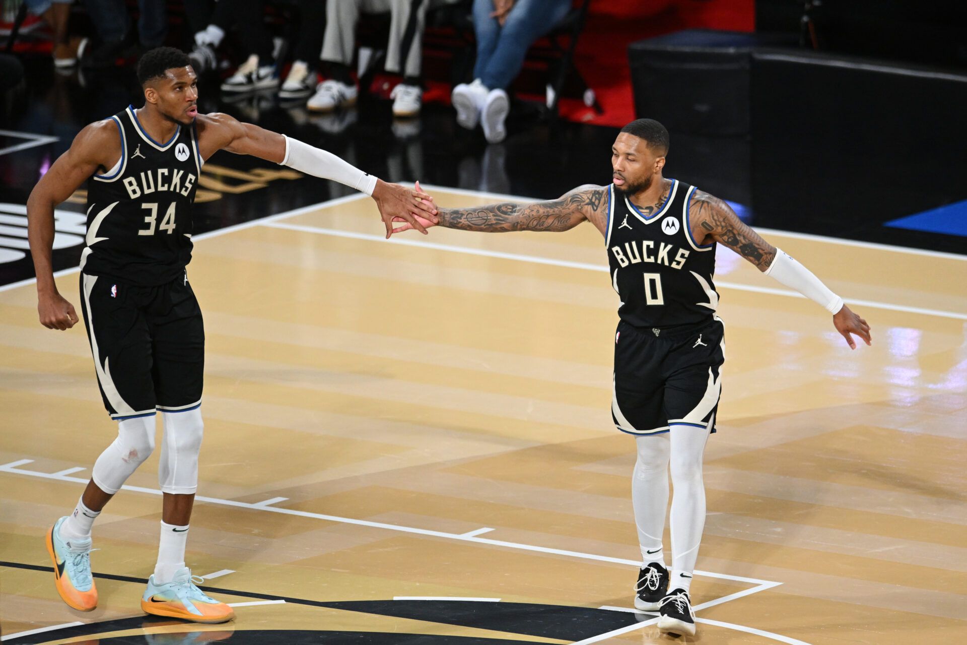 Milwaukee Bucks guard Damian Lillard (0) and forward Giannis Antetokounmpo (34) react during the fourth quarter against the Atlanta Hawks in a semifinal of the 2024 Emirates NBA Cup at T-Mobile Arena.