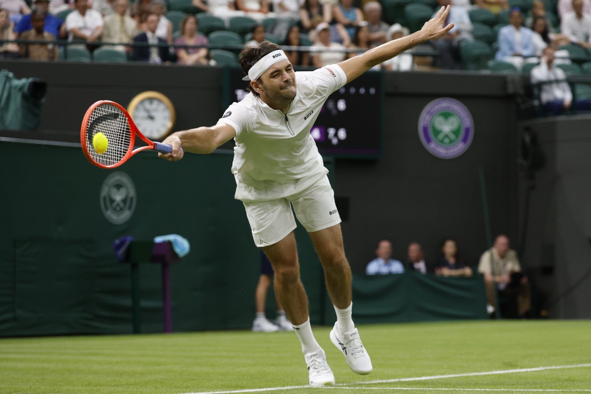 Taylor Fritz (USA) reaches for a forehand against Giovanni Mpetshi Perricard (FRA)(not pictured) on day one of The Championships, Wimbledon 2025 at All England Lawn Tennis and Croquet Club.