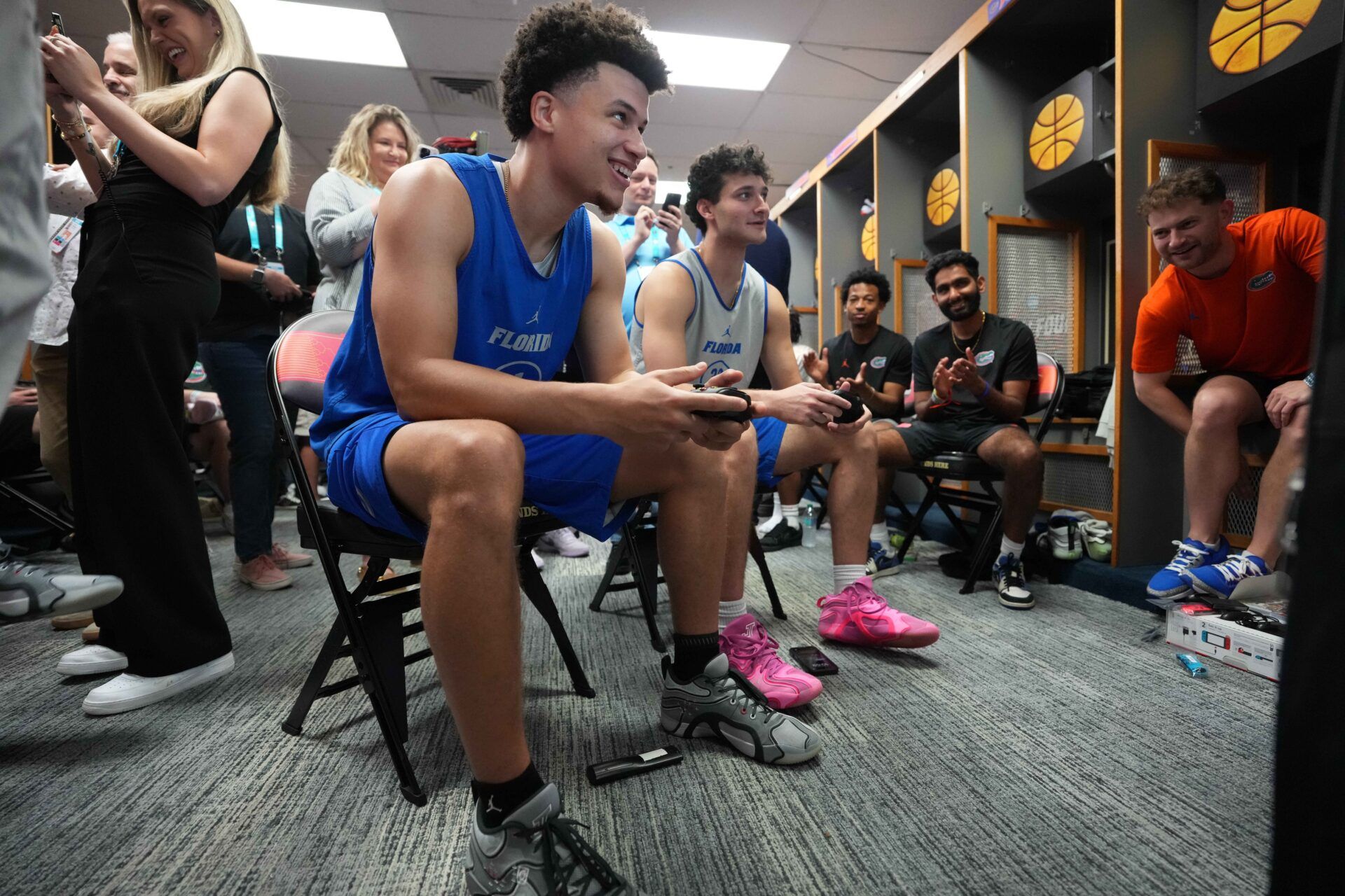 Florida Gators guard Walter Clayton Jr. (1) and guard Cooper Josefsberg (33) play a video game during open locker room at Alamodome.