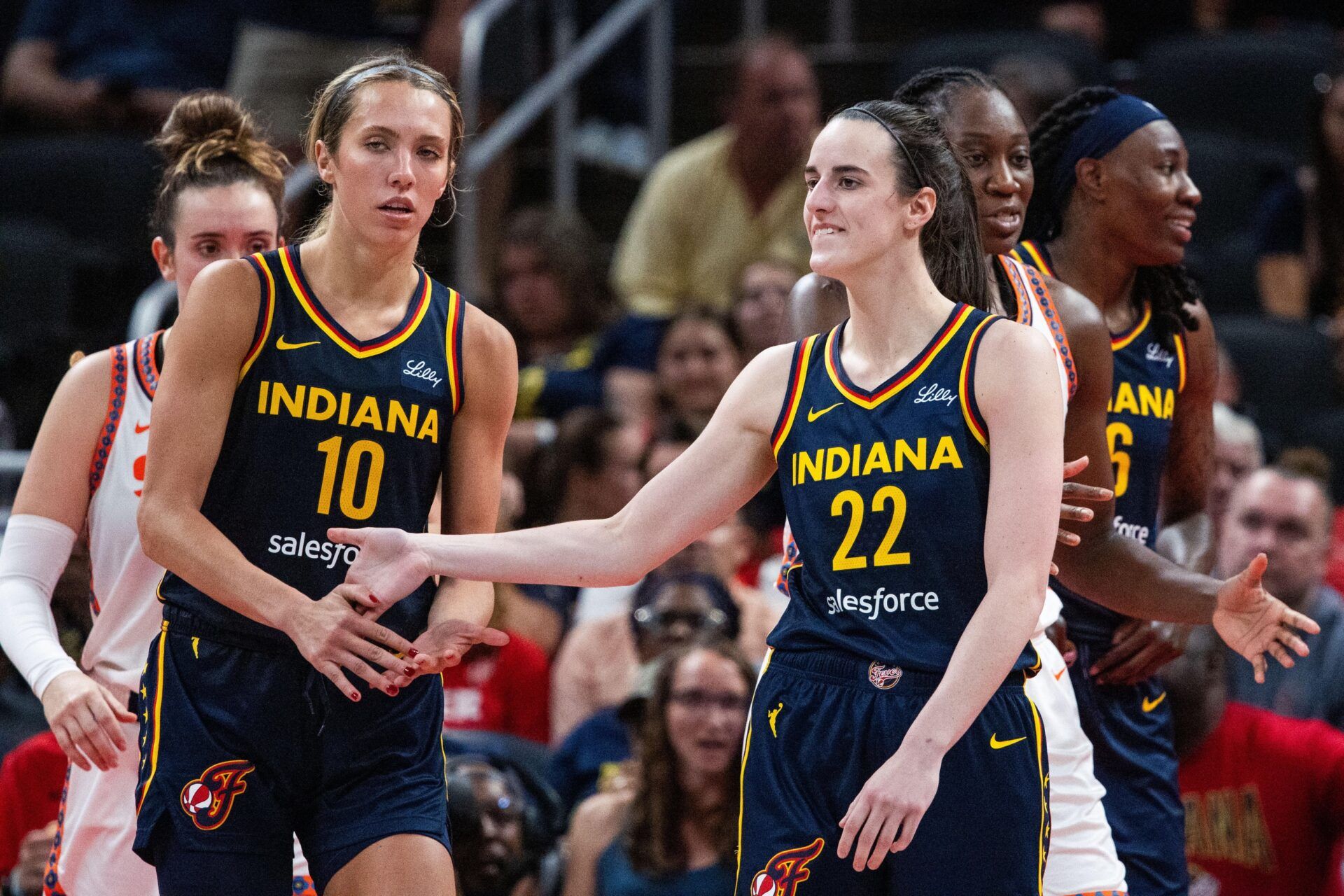 Indiana Fever guard Caitlin Clark (22) and guard Lexie Hull (10) celebrate after a play in the second half against the Connecticut Sun at Gainbridge Fieldhouse.