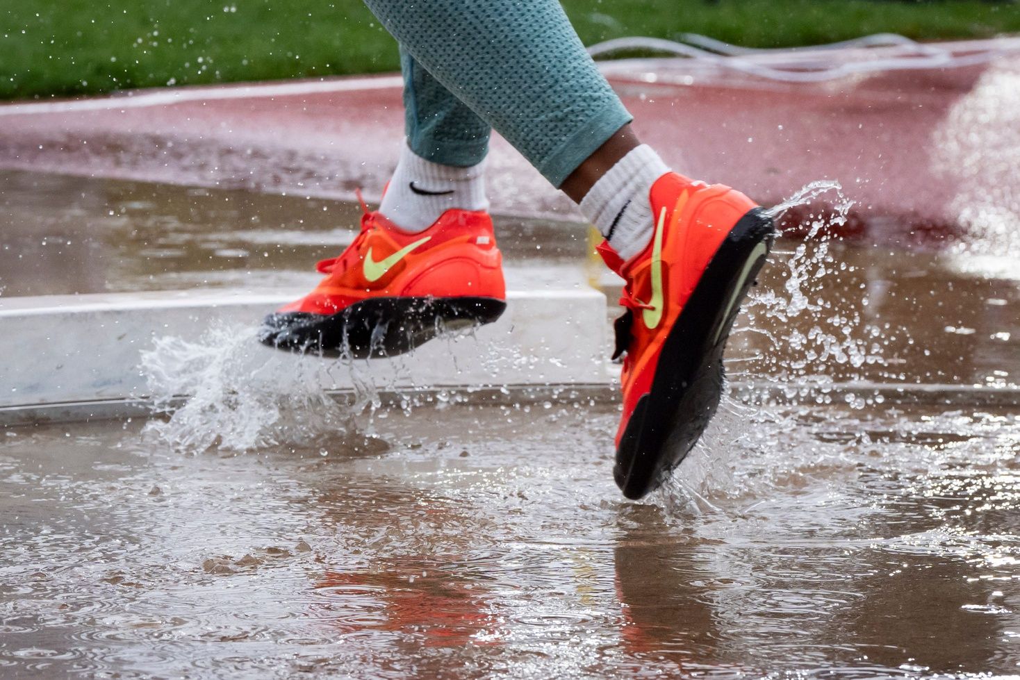 Water splashes in the shot put ring as throwers compete on the third day of the Nike Outdoor Nationals on June 21, 2025, at Hayward Field in Eugene.