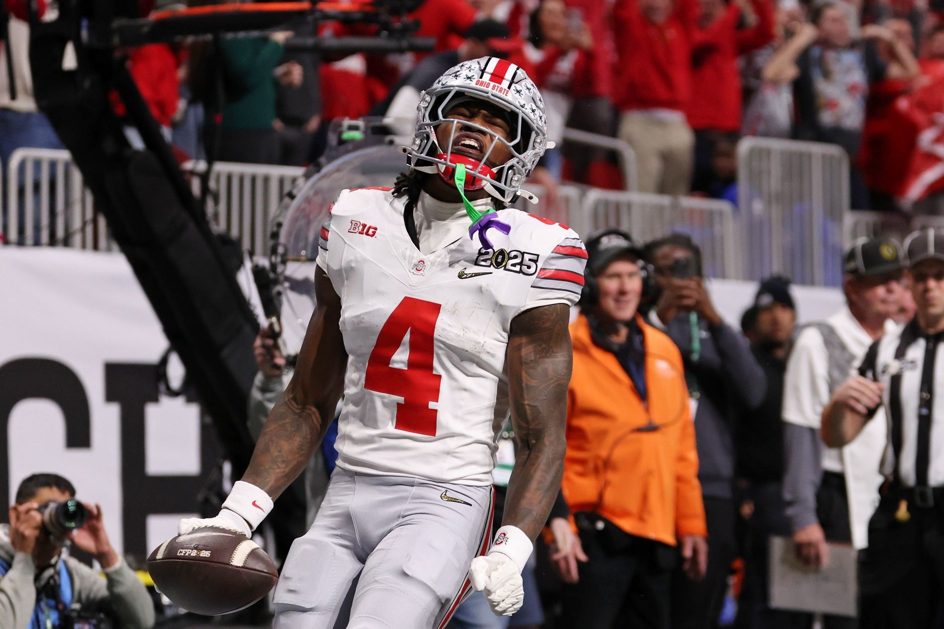 Ohio State Buckeyes wide receiver Jeremiah Smith (4) reacts after scoring against the Notre Dame Fighting Irish a touchdown during the first half the CFP National Championship college football game at Mercedes-Benz Stadium.