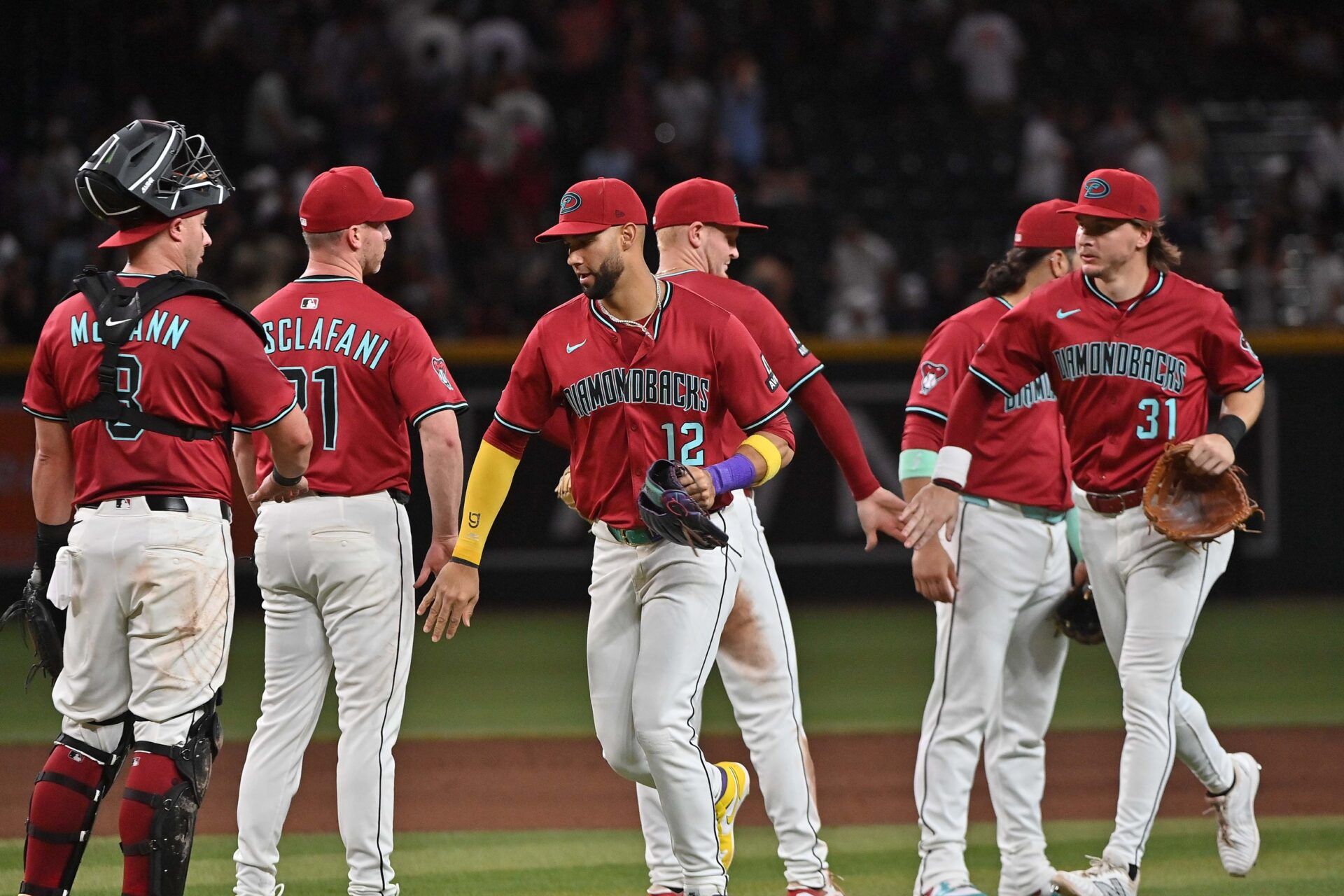 Arizona Diamondbacks pitcher Anthony DeSclafani (21) celebrates with catcher James McCann (8), outfielder Lourdes Gurriel Jr. (12) and outfielder Jake McCarthy (31)after beating the San Francisco Giants  at Chase Field.