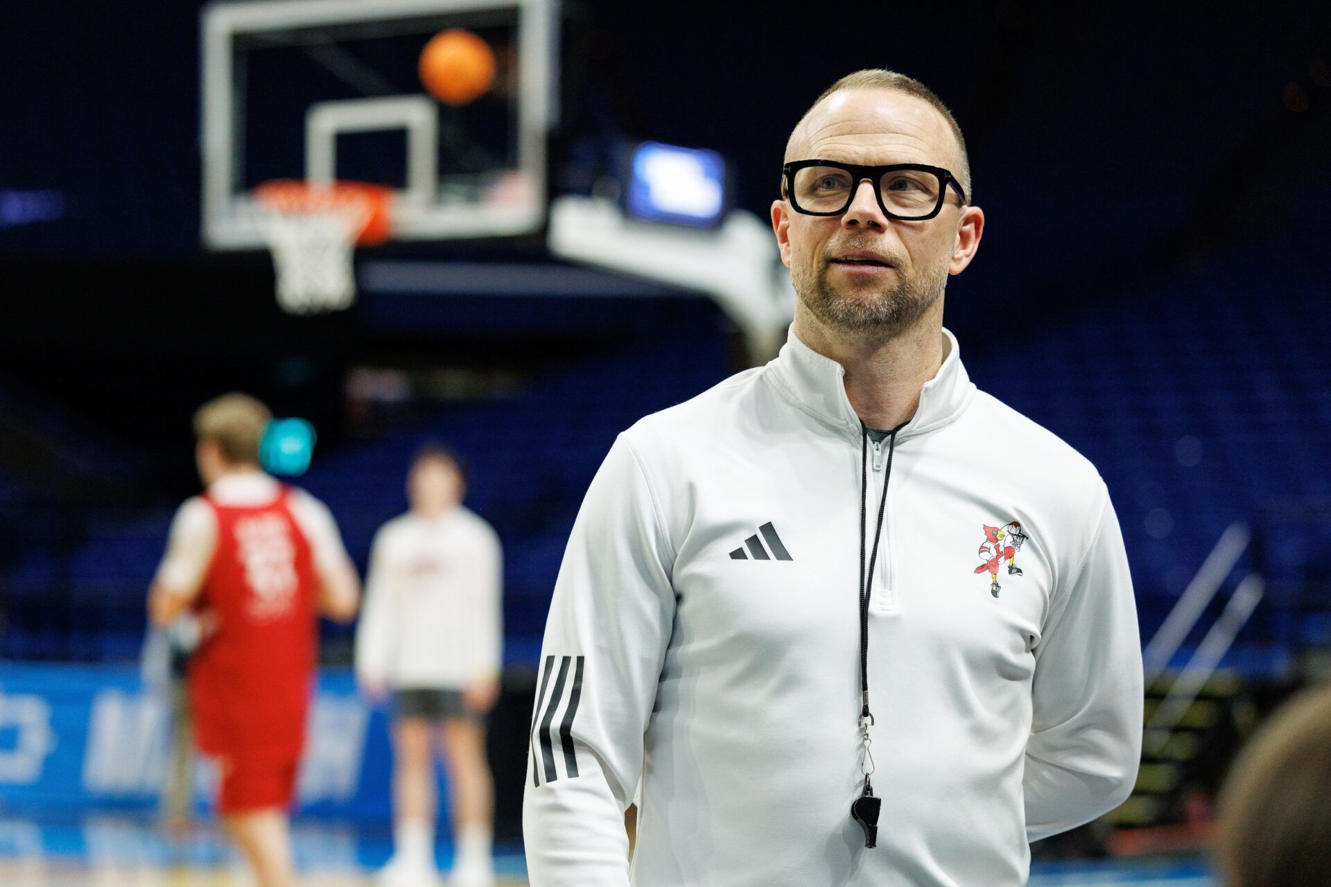 Louisville Cardinals head coach Pat Kelsey talks to media members on the sideline during practice at Rupp Arena.