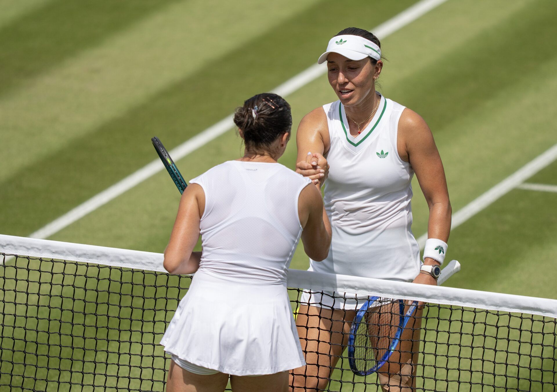 Jessica Pegula of the United States at the net with Elisabetta Cocciaretto of Italy after their match on day two at the All England Lawn Tennis and Croquet Club.