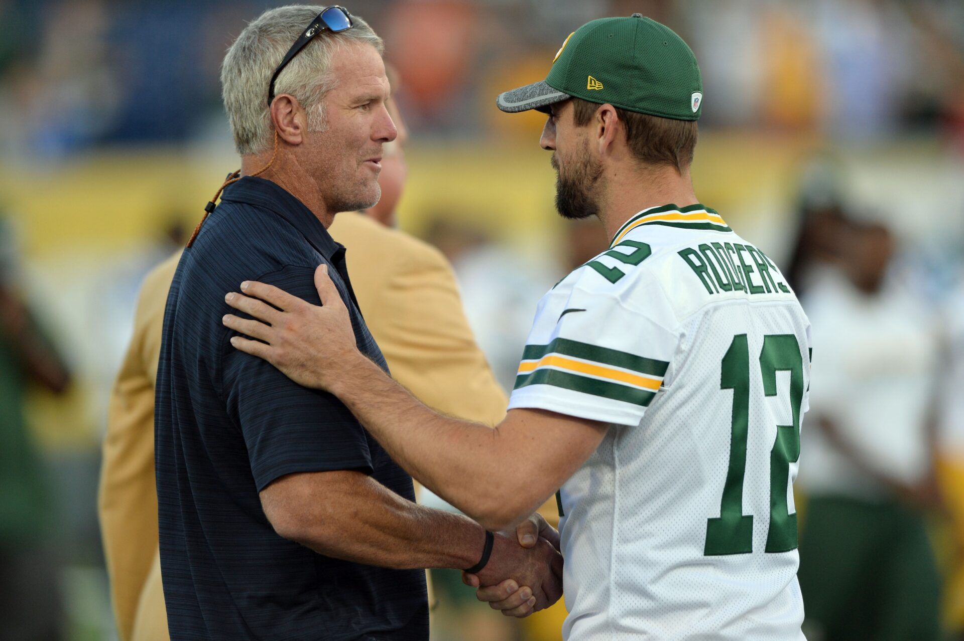 Green Bay Packers quarterback Aaron Rodgers (12) greets Hall of Fame member Brett Favre before the game between the Indianapolis Colts and the Green Bay Packers at the 2016 Hall of Fame Game at Tom Benson Hall of Fame Stadium. The game was cancelled due to safety concerns with the condition of the playing surface.