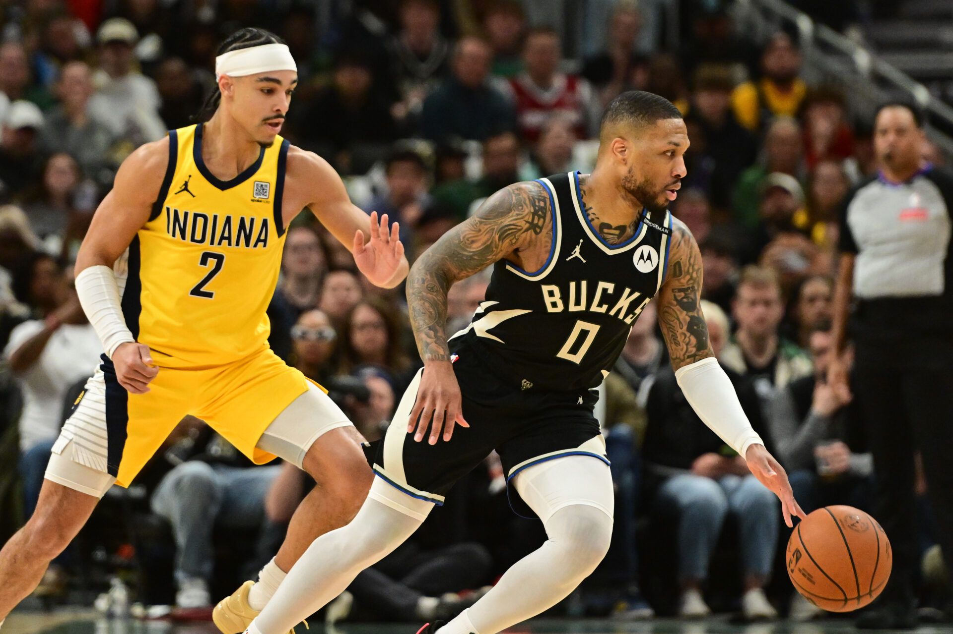 Milwaukee Bucks guard Damian Lillard (0) drives for the basket against Indiana Pacers guard Andrew Nembhard (2) in the first quarter during game four of first round for the 2024 NBA Playoffs at Fiserv Forum. Lillard left the game early in the in the first quarter with an injury.