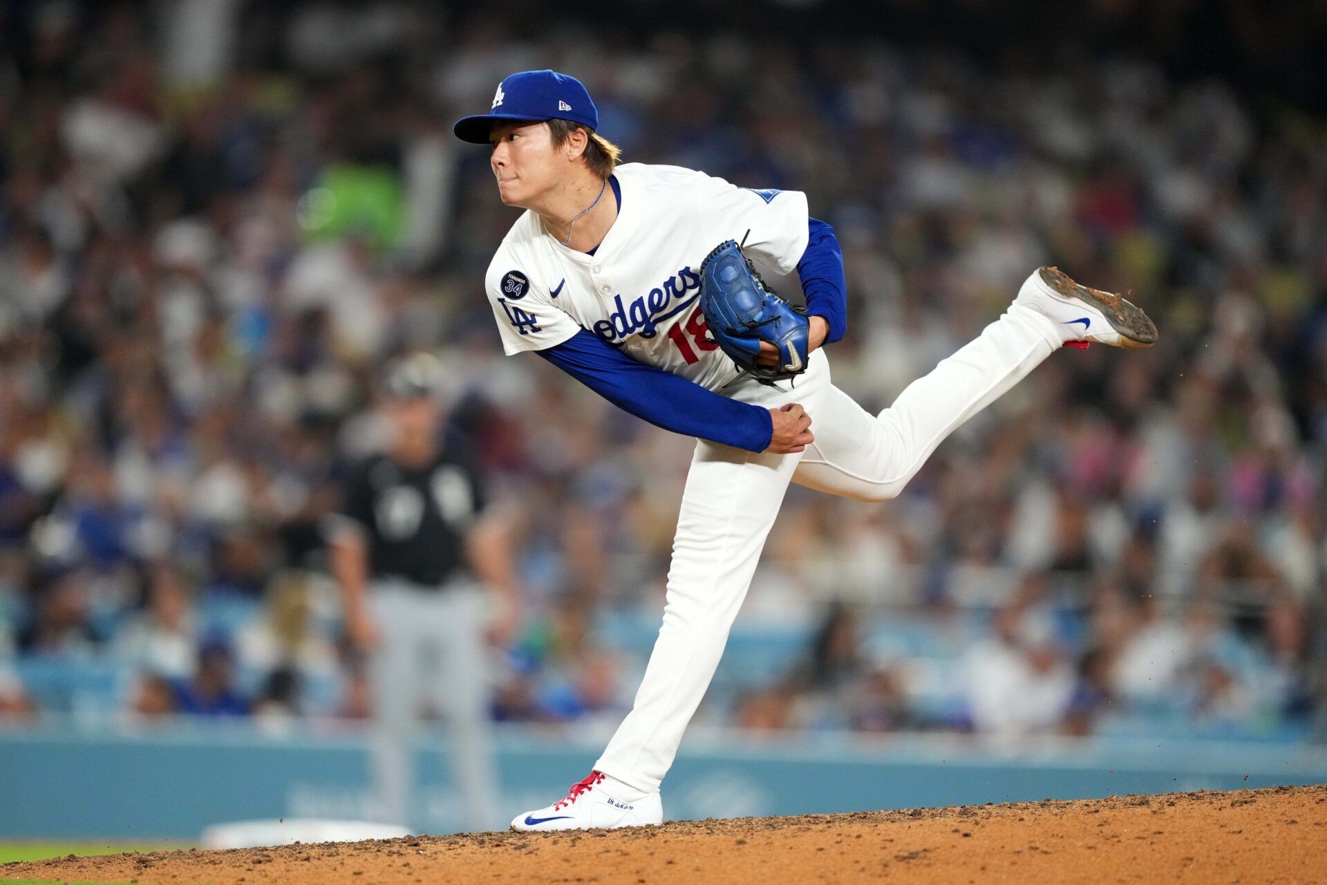 Los Angeles Dodgers starting pitcher Yoshinobu Yamamoto (18) throws in the seventh inning against the Chicago White Sox at Dodger Stadium.