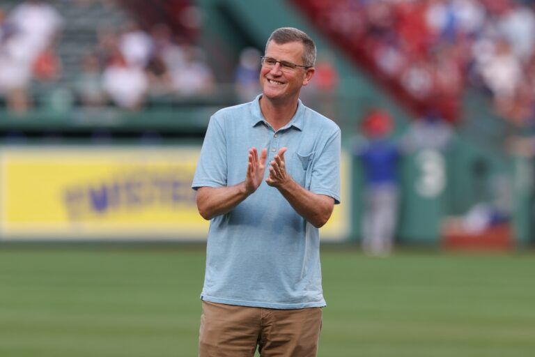 President and CEO of the Boston Red Sox Sam Kennedy applauds before a game against the Kansas City Royals at Fenway Park.