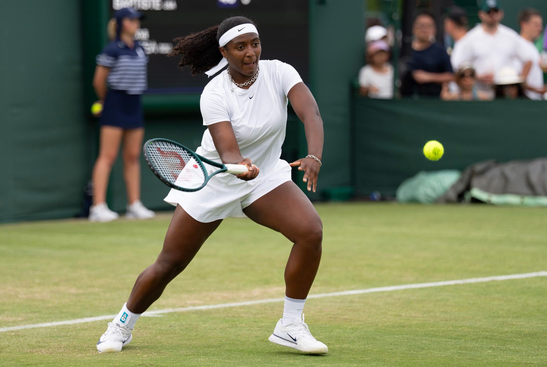 Hailey Baptiste of the United States returns a shot during her match against Sorana Cirstea of Romania on day two at the All England Lawn Tennis and Croquet Club.