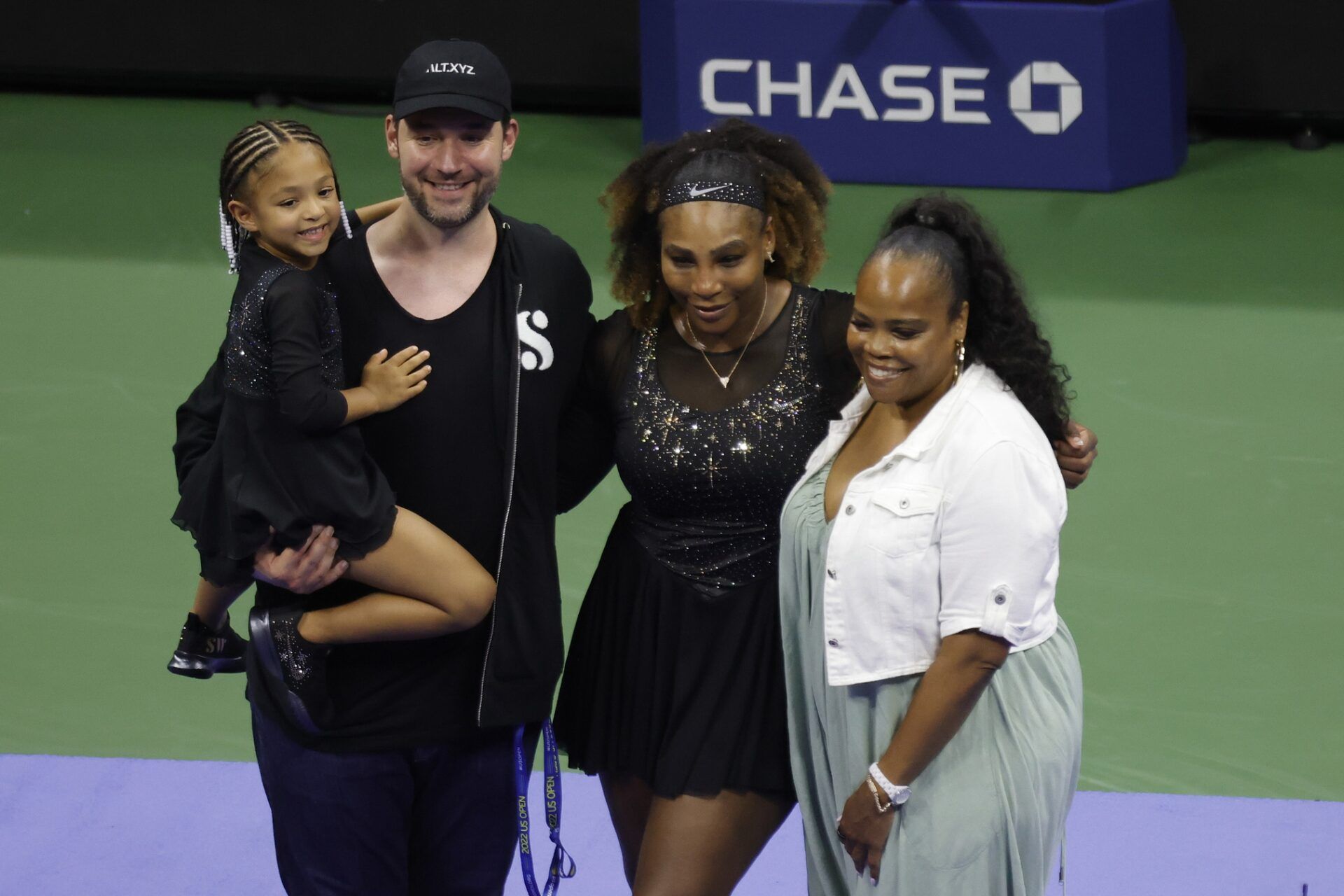 Serena Williams (USA) (M-L) poses for a picture with daughter Olympia (L), husband Alexis Ohanian (M-L), and sister Isha Price (R) after a ceremony honoring her career after her match against Danka Kovinic (MNE) (not pictured) on day one of the 2022 U.S. Open tennis tournament at USTA Billie Jean King National Tennis Center.