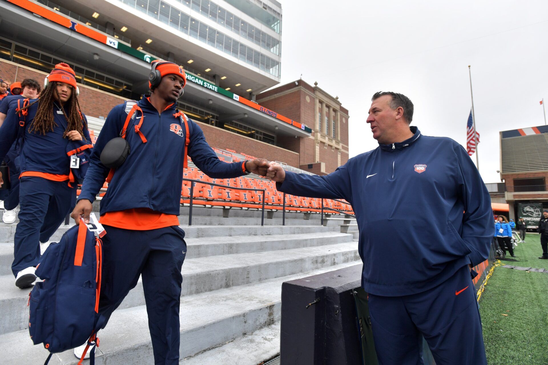 Illinois Fighting Illini head coach Bret Bielema gives a hand to players before the game against the Michigan State Spartans at Memorial Stadium.