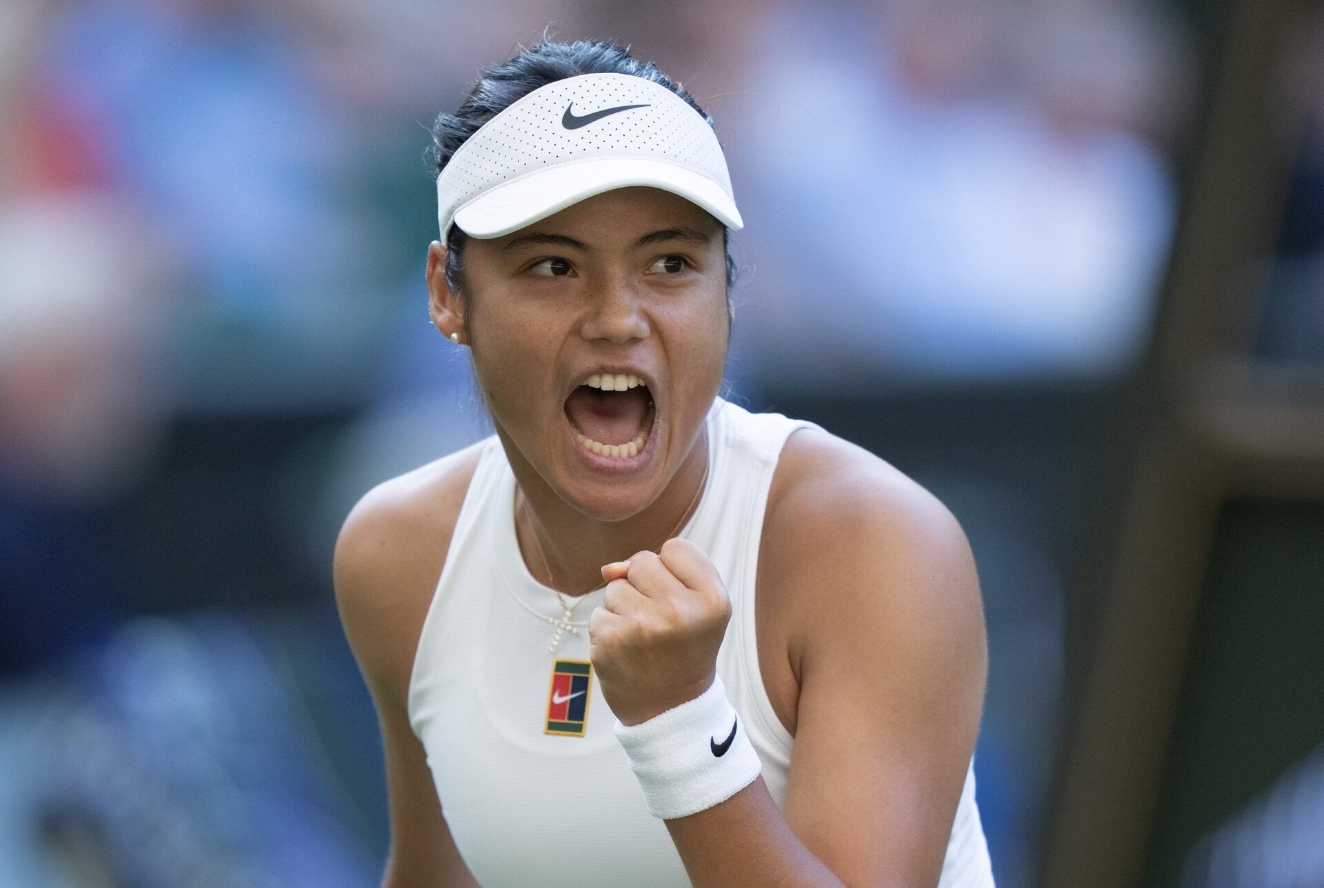 Emma Raducanu of Great Britain reacts to a point during her match against Marketa Vondrousova of the Czech Republic on day three at the All England Lawn Tennis and Croquet Club.