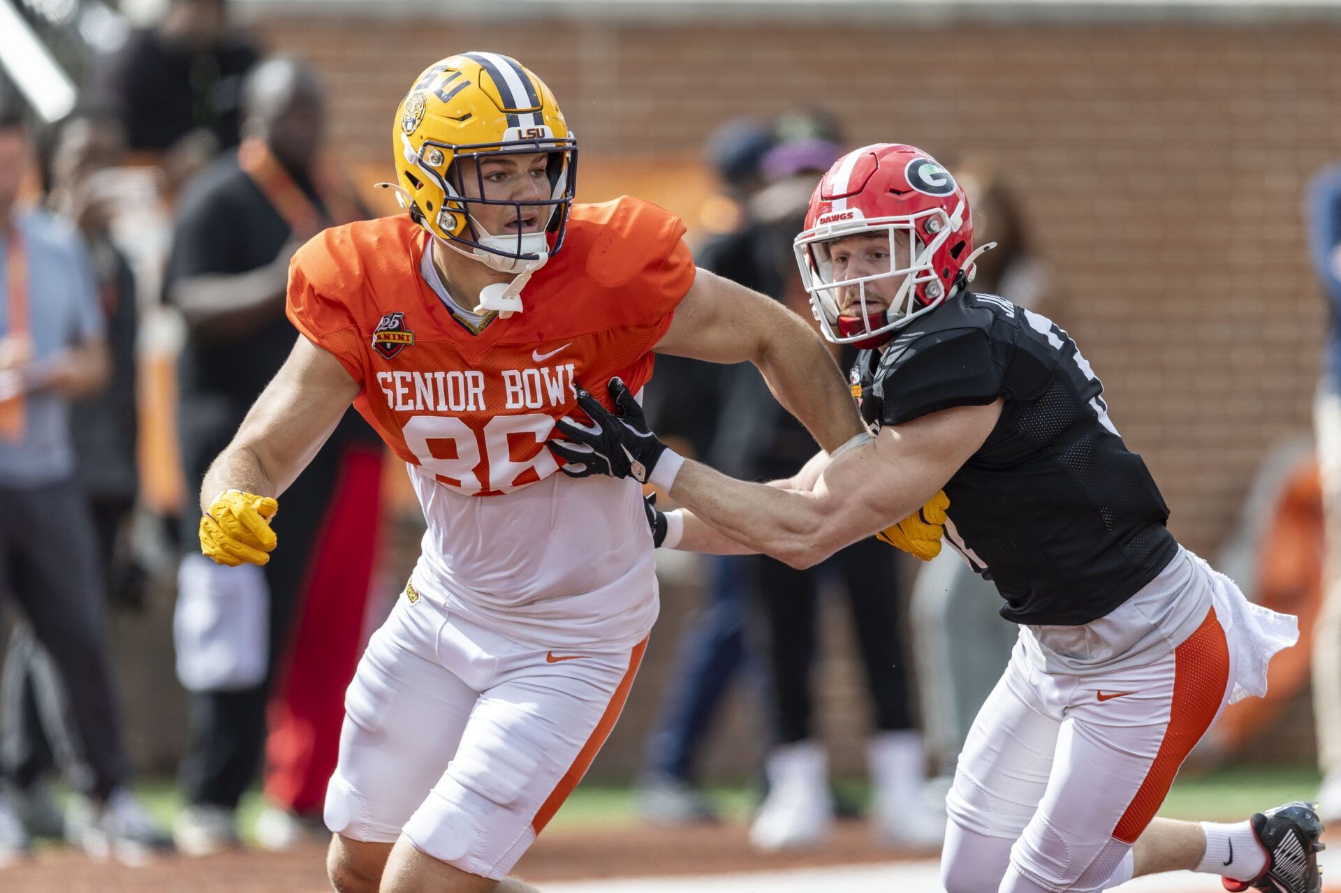 American team tight end Mason Taylor of LSU (86) and American team defensive back Dan Jackson of Georgia (37) spar during Senior Bowl practice for the American team at Hancock Whitney Stadium.