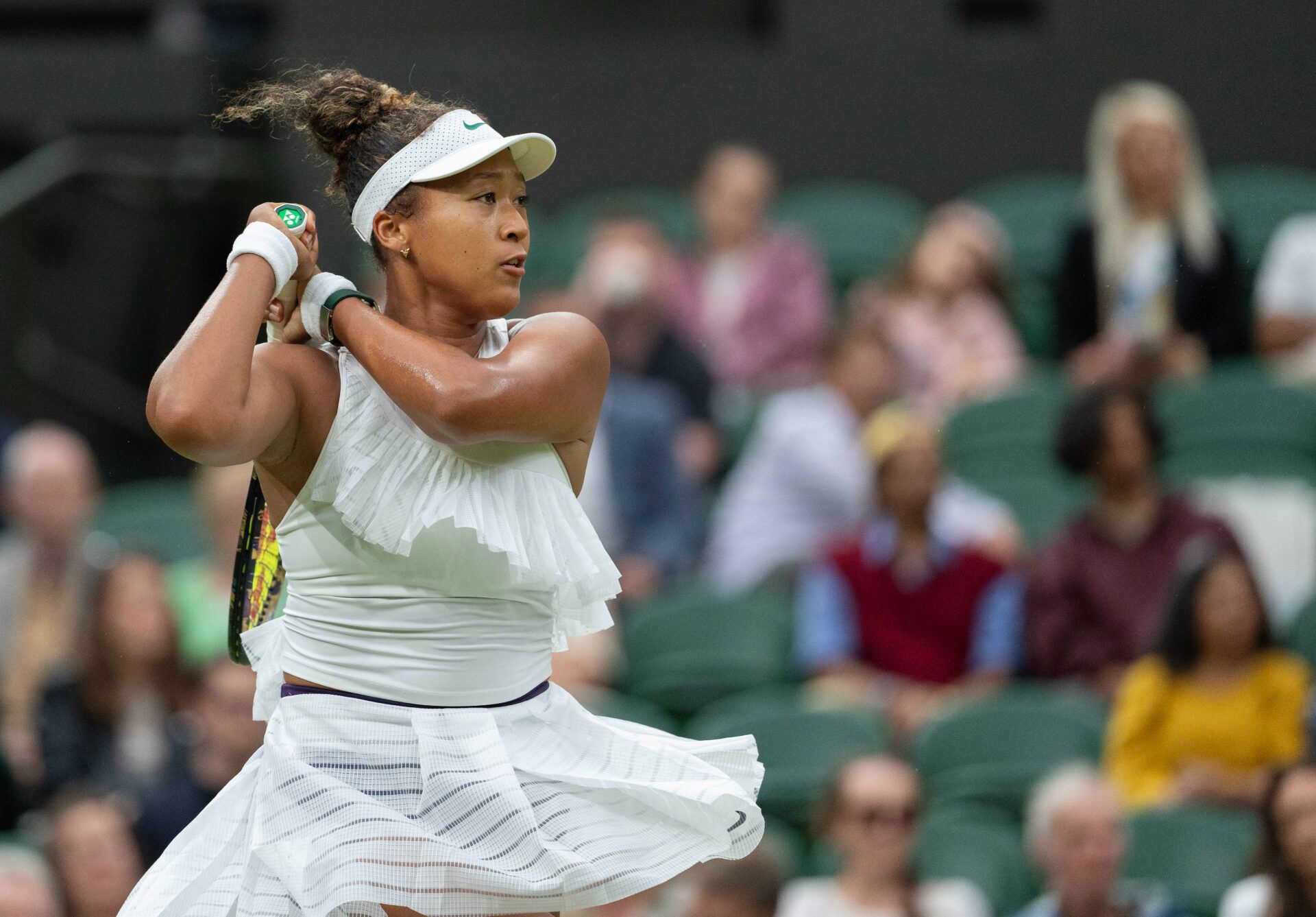 Naomi Osaka of Japan follows through on a shot during her match against Emma Navarro of the United States (not shown) on day three of The Championships at All England Lawn Tennis and Croquet Club.