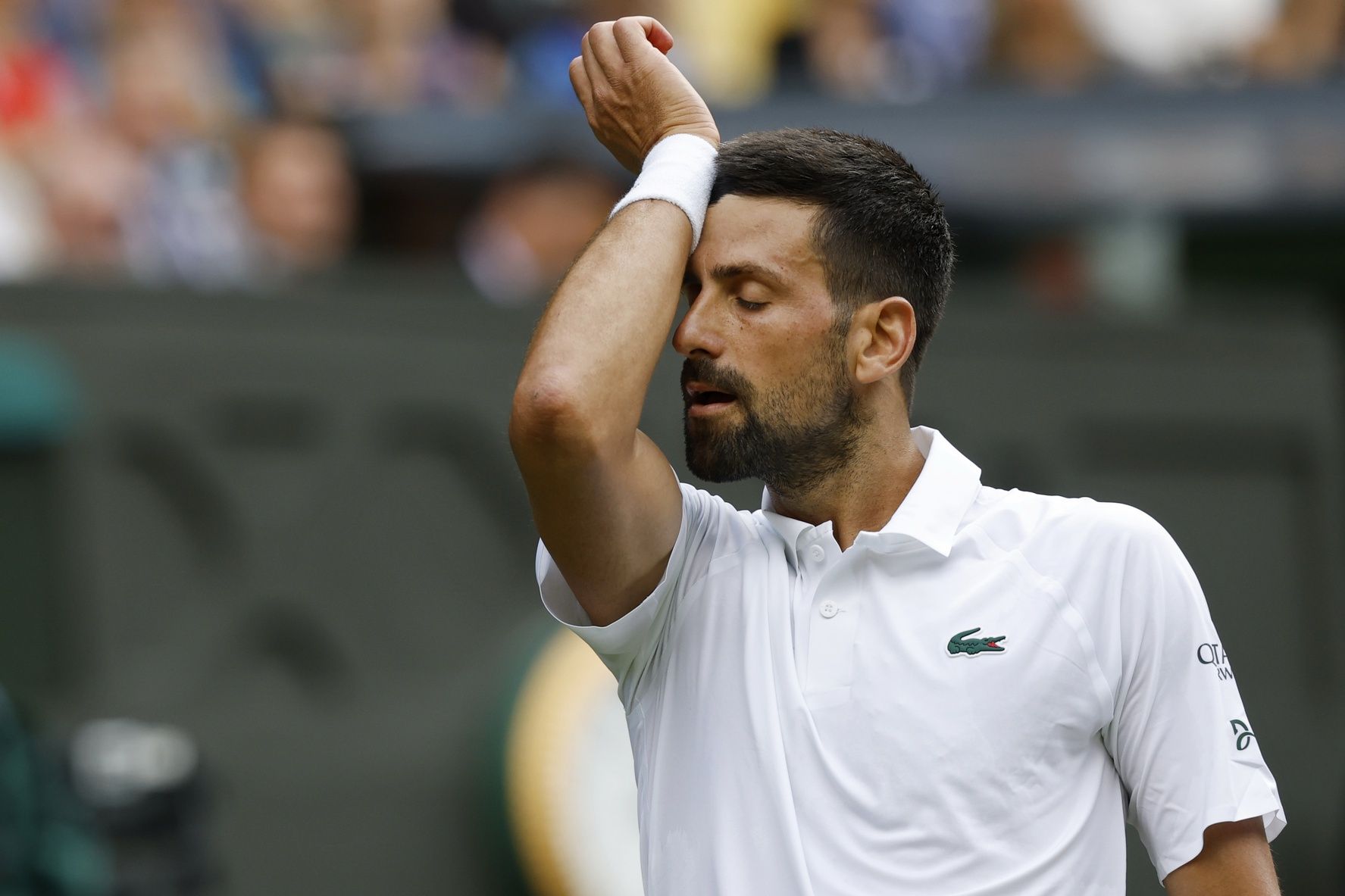 Novak Djokovic (SRB) wipes his face between points against Daniel Evans (GBR)(not pictured) on day four of The Championships Wimbledon 2025 at All England Lawn Tennis and Croquet Club.