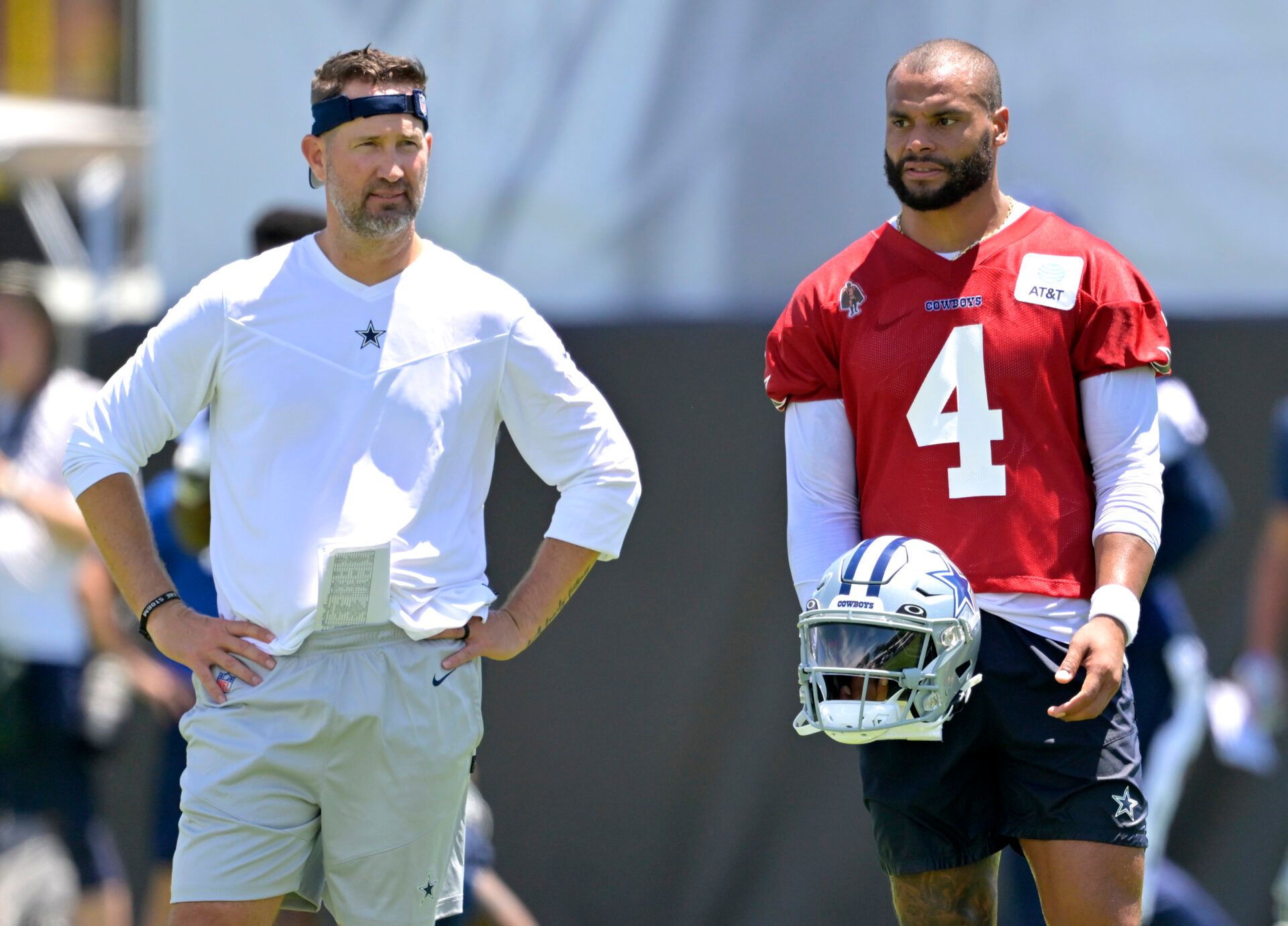 Dallas Cowboys quarterback Dak Prescott (4) talks with HC Brian Schottenheimer during training camp at River Ridge Playing Fields in Oxnard, CA.
