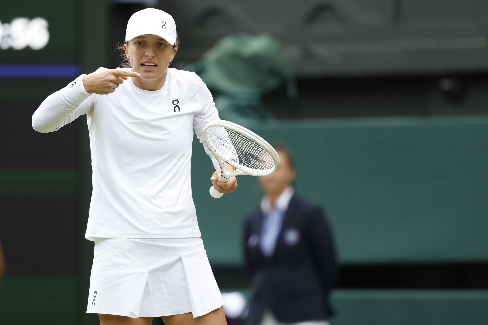 Iga Swiatek (POL) gestures to her player's box after missing a shot against Petra Martic (CRO)(not pictured) in a ladies' singles match on day four of The Championships Wimbledon 2024 at All England Lawn Tennis and Croquet Club.