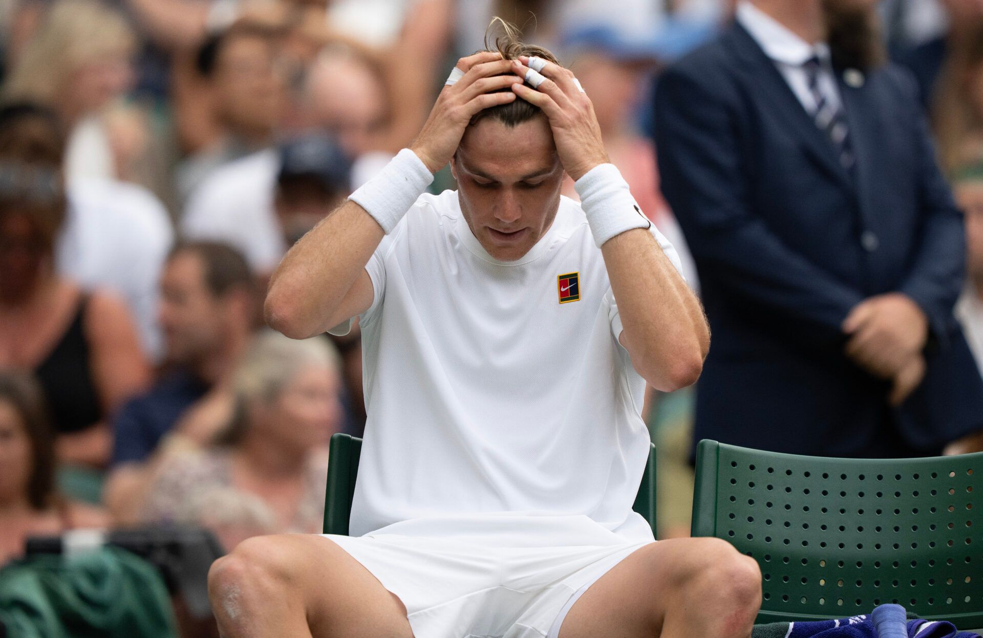 Jack Draper of Great Britain at a change of ends during his match against Marin Cilic of Croatia on day four at the All England Lawn Tennis and Croquet Club.