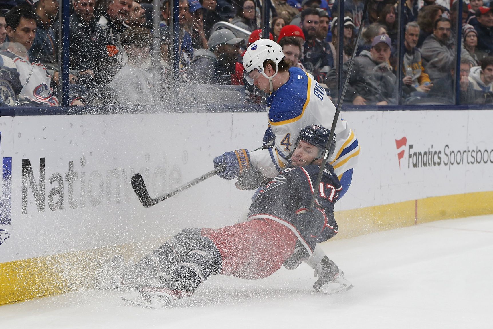 Columbus Blue Jackets right wing Justin Danforth (17) and Buffalo Sabres defenseman Bowen Byram (4) battle for the puck during the second period at Nationwide Arena.