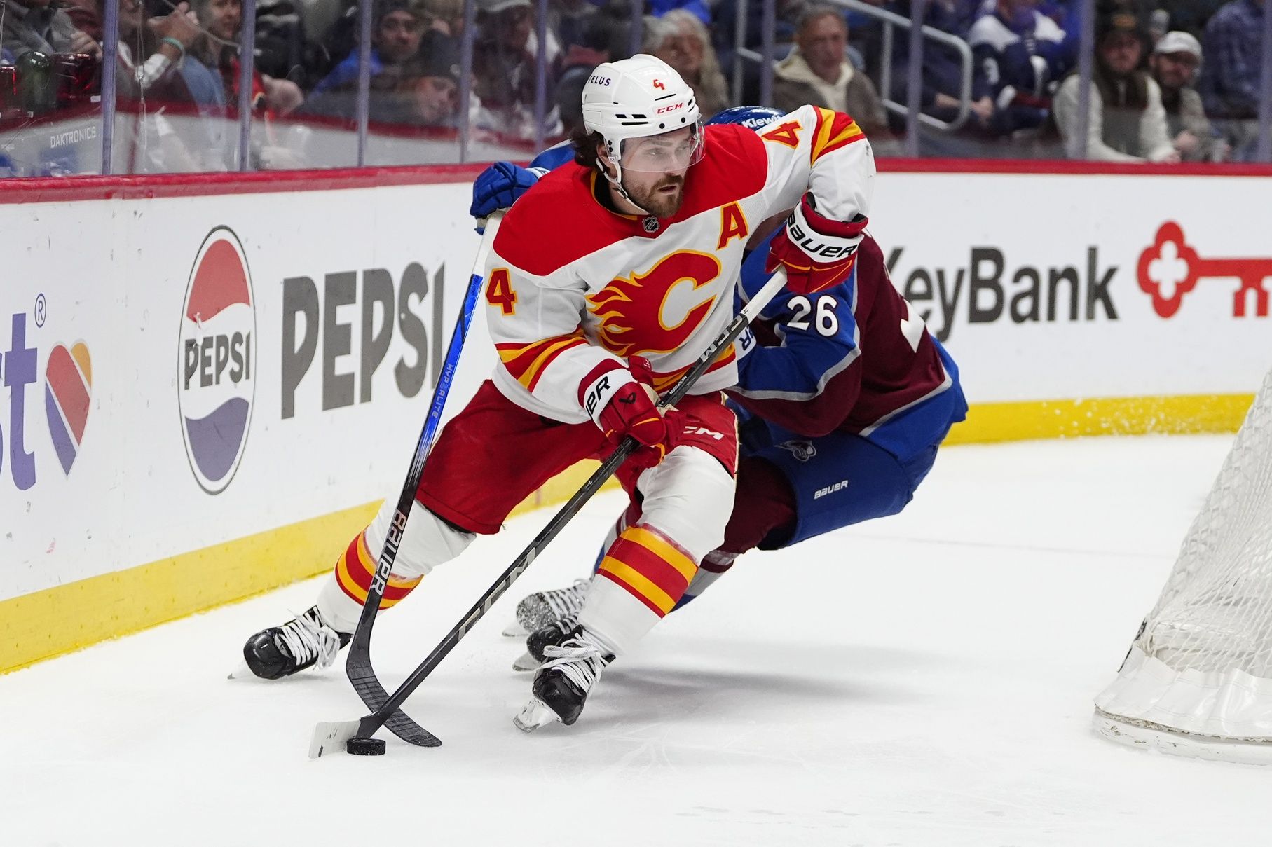 Colorado Avalanche left wing Jimmy Vesey (26) defends on Calgary Flames defenseman Rasmus Andersson (4) in the second period at Ball Arena.