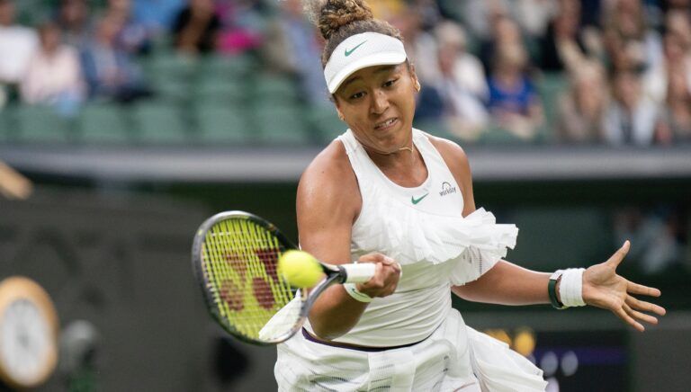Naomi Osaka of Japan returns a shot during her match against Emma Navarro of the United States (not shown) on day three of The Championships at All England Lawn Tennis and Croquet Club.
