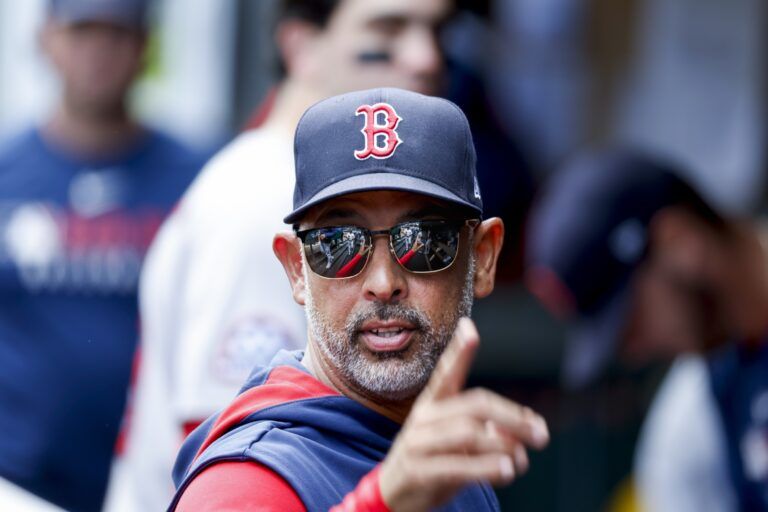 Boston Red Sox manager Alex Cora (13) stands in the dugout following the inning against the Seattle Mariners at T-Mobile Park.