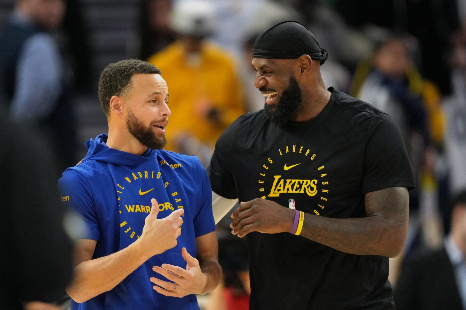 Golden State Warriors guard Stephen Curry (left) and Los Angeles Lakers forward LeBron James (right) talk before the game at Chase Center.