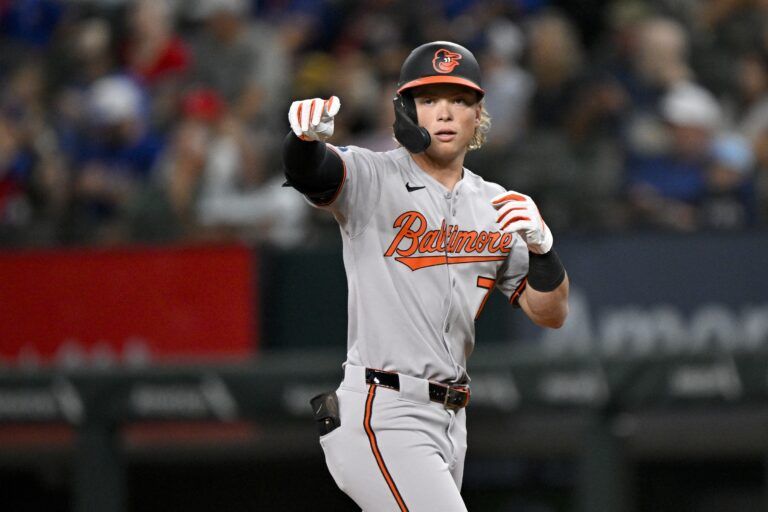 Baltimore Orioles second baseman Jackson Holliday (7) points to the bench after he hits a leadoff single against the Texas Rangers during the first inning at Globe Life Field.
