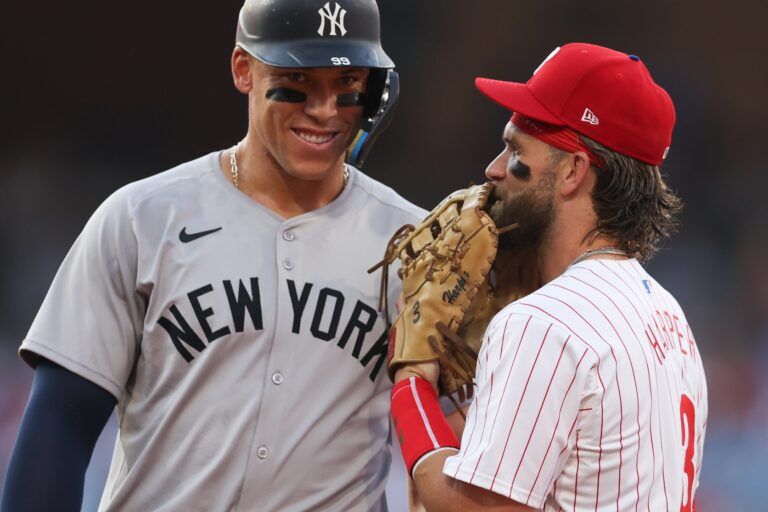 New York Yankees outfielder Aaron Judge (99) with Philadelphia Phillies first base Bryce Harper (3) on first base after his single during the first inning at Citizens Bank Park.