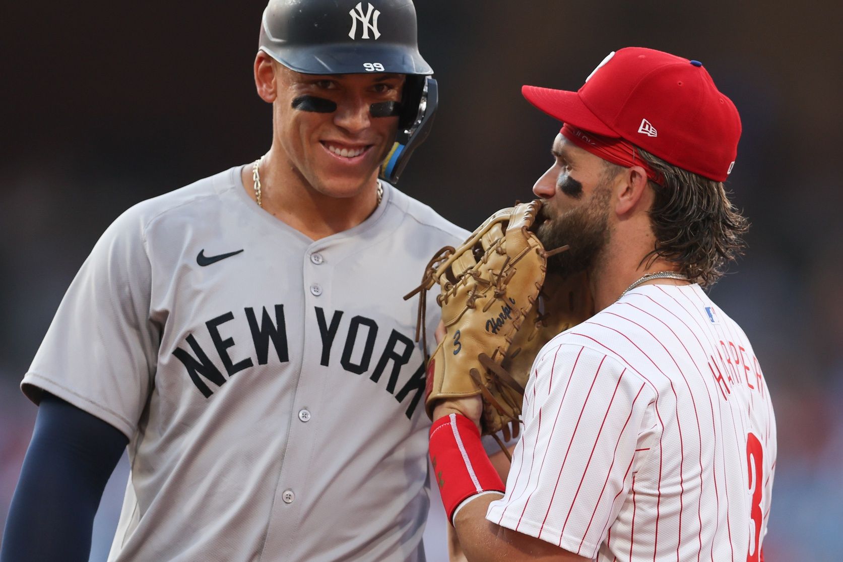 New York Yankees outfielder Aaron Judge (99) with Philadelphia Phillies first base Bryce Harper (3) on first base after his single during the first inning at Citizens Bank Park.