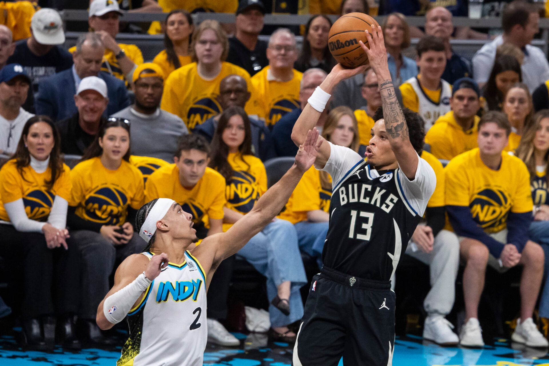 Milwaukee Bucks guard Ryan Rollins (13) shoots the ball while Indiana Pacers guard Andrew Nembhard (2) defends in the first half at Gainbridge Fieldhouse.