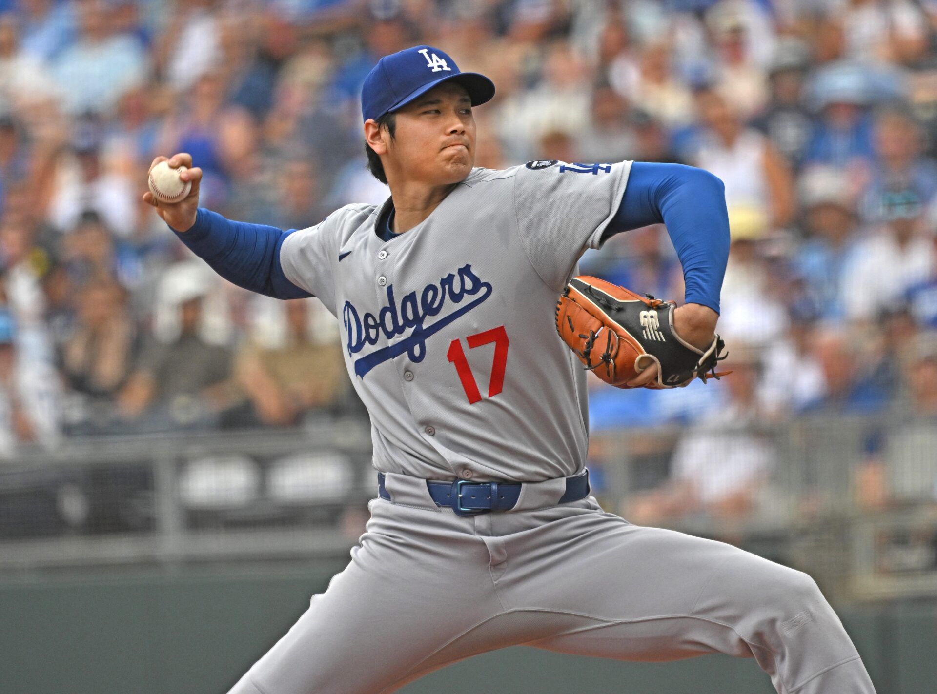 Los Angeles Dodgers designated hitter Shohei Ohtani (17) throws a pitch in the first inning against the Kansas City Royals  at Kauffman Stadium.